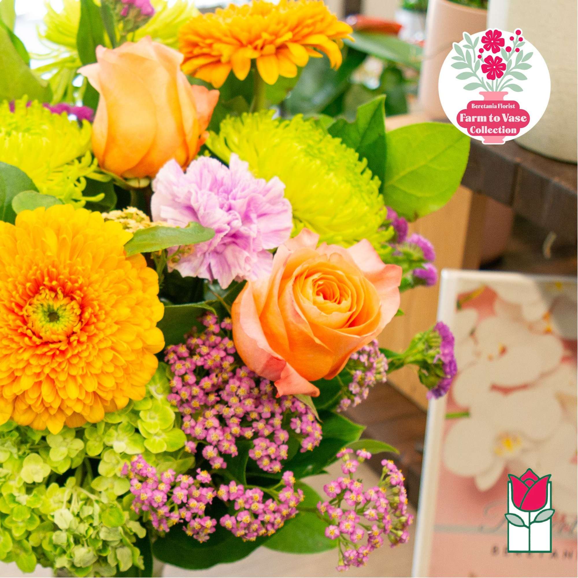 Bouquet of orange roses, yellow chrysanthemums, and pink flowers