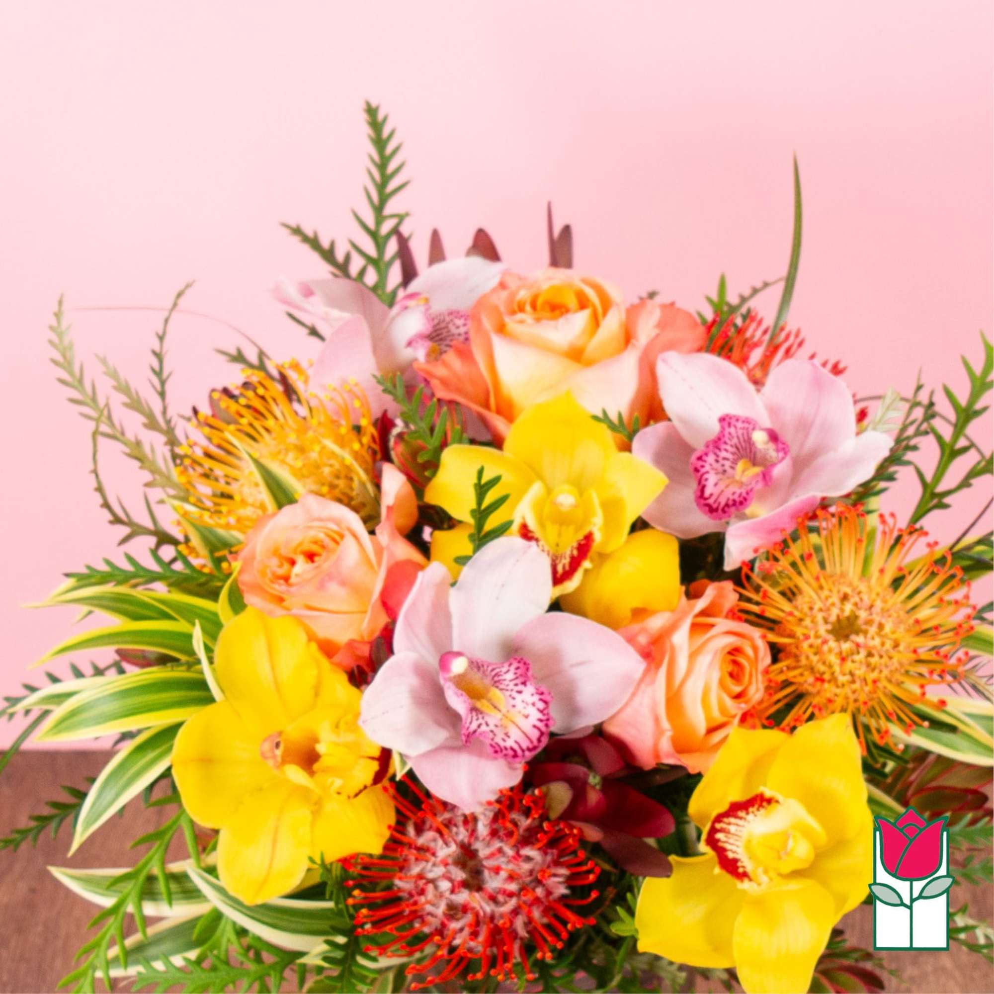Bouquet of yellow orchids, peach roses, and pink orchids