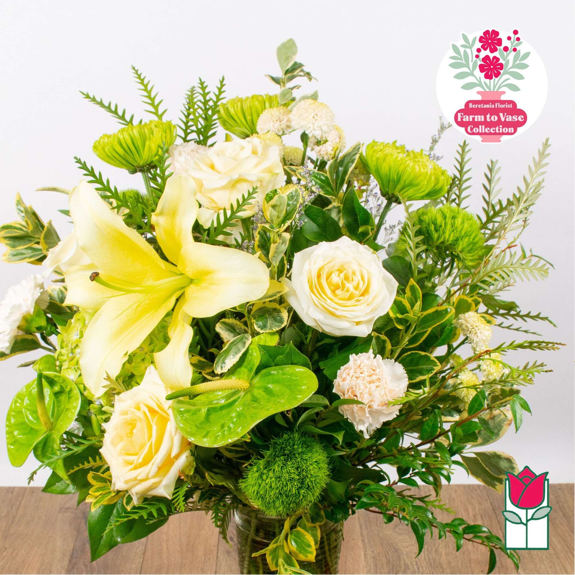 Yellow lilies and white roses in a glass vase