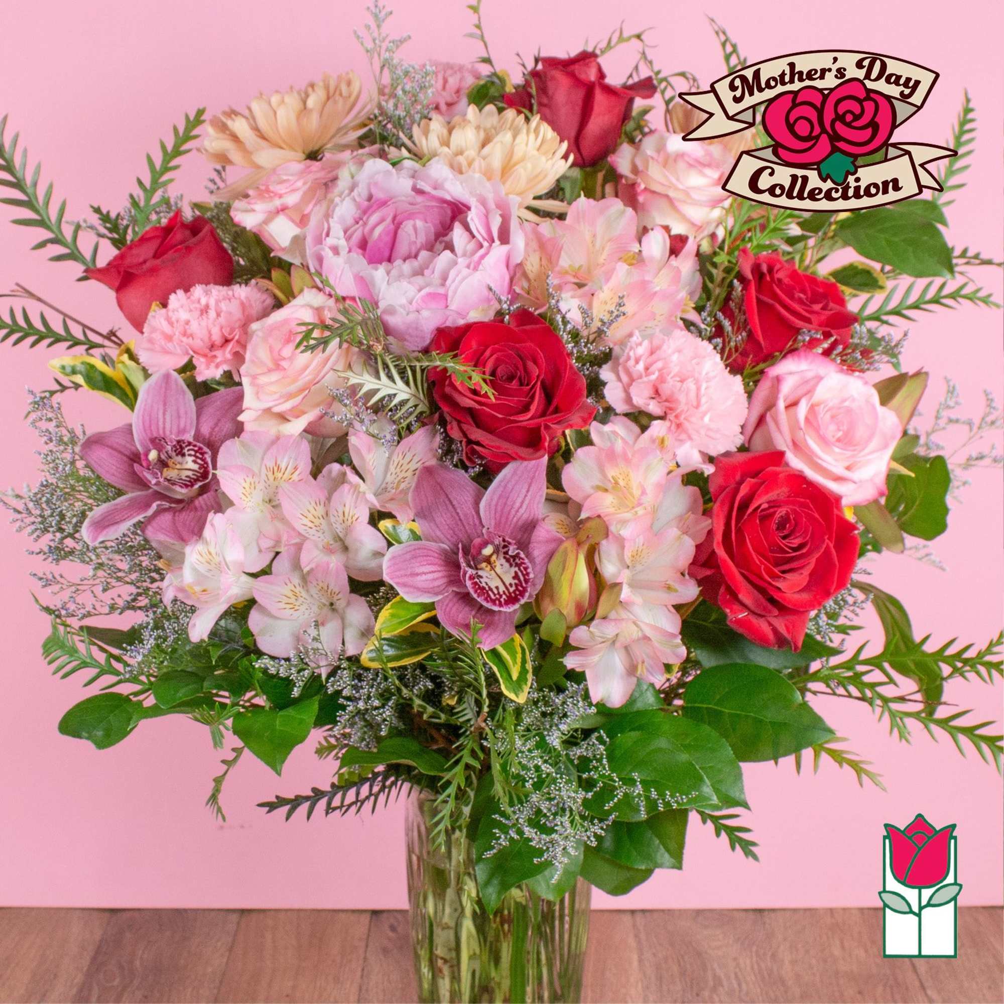 Mixed bouquet of pink peonies, orchids, roses, and carnations in a clear glass vase on a pink background
