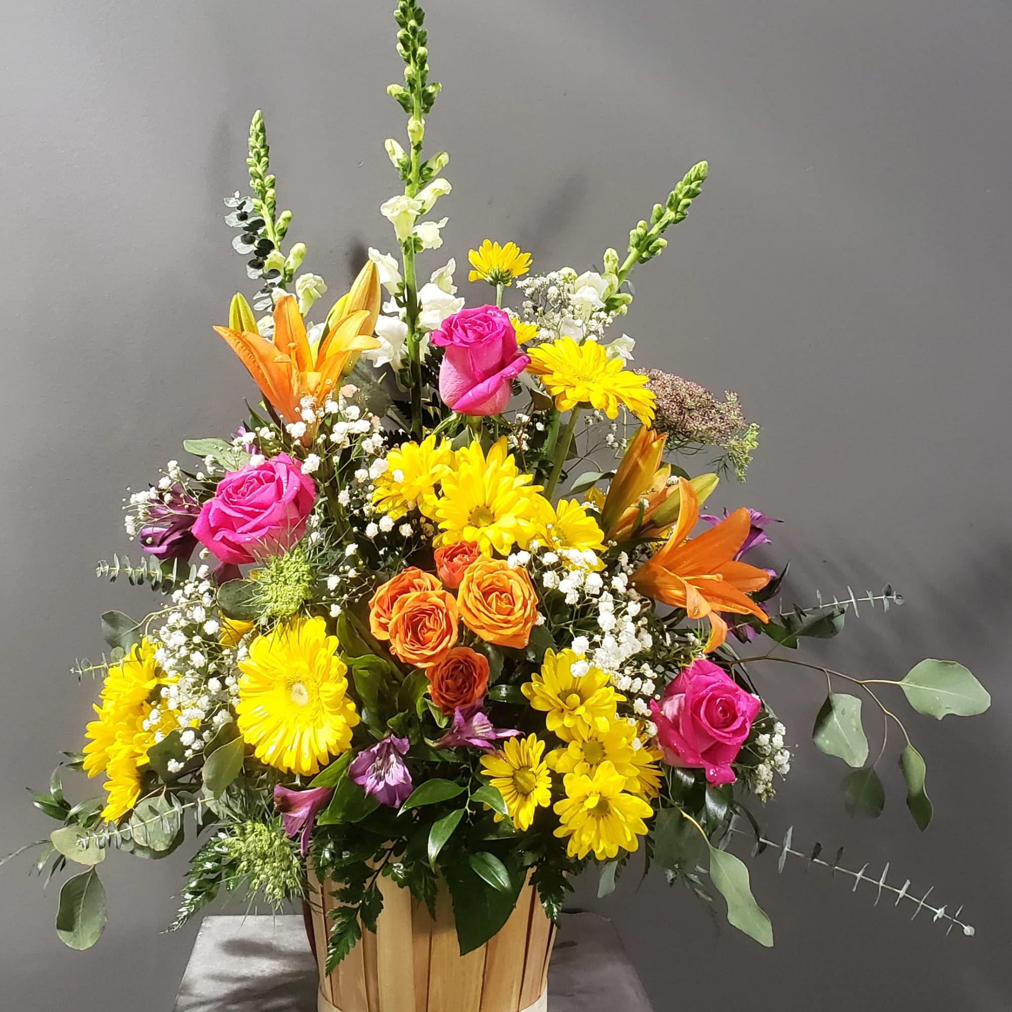 A basket of Snapdragons, Queen Ann's Lace, Daisies, Roses, Lilies, Austromeria, Salal