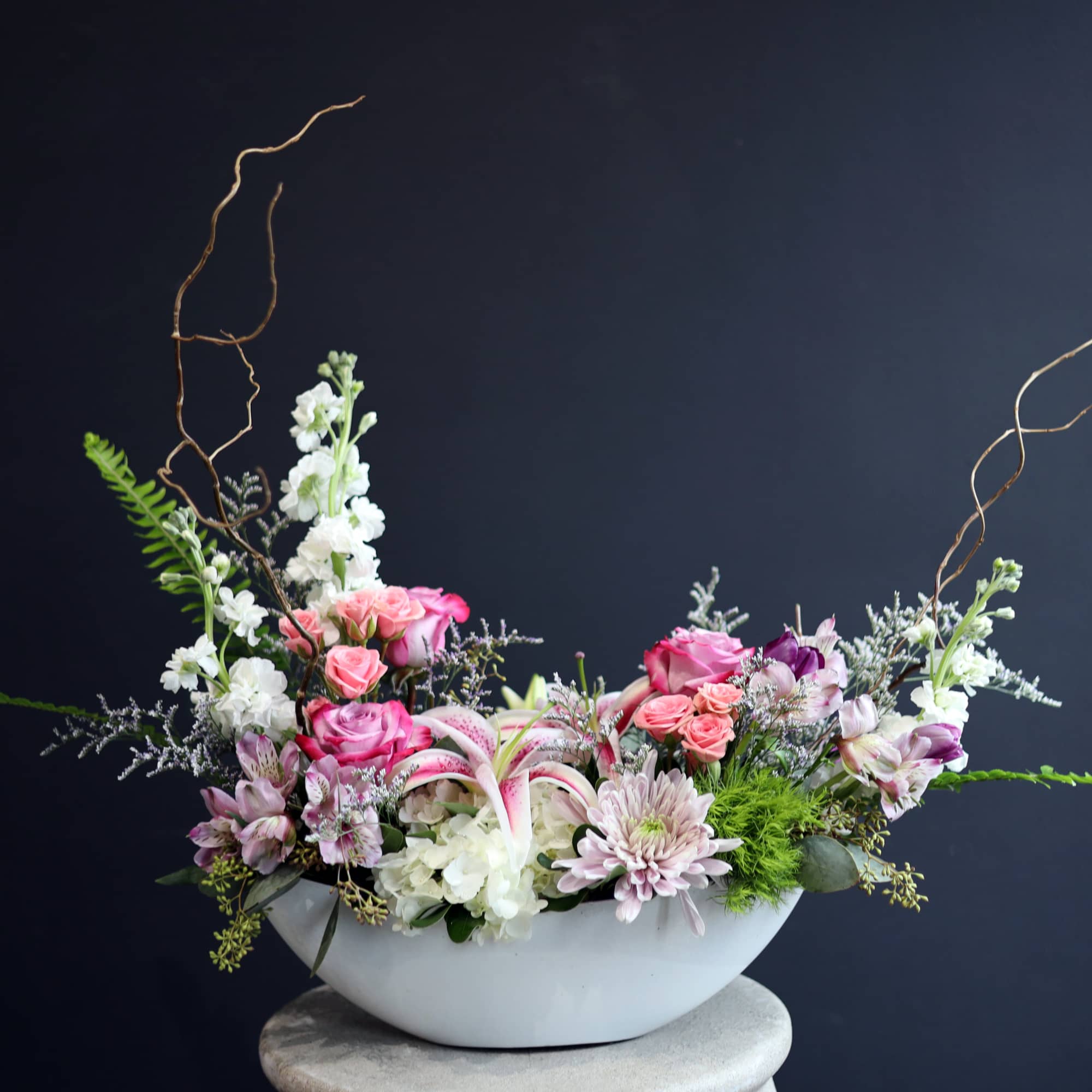 This boat vase is filled with lovely premium flowers! A few in