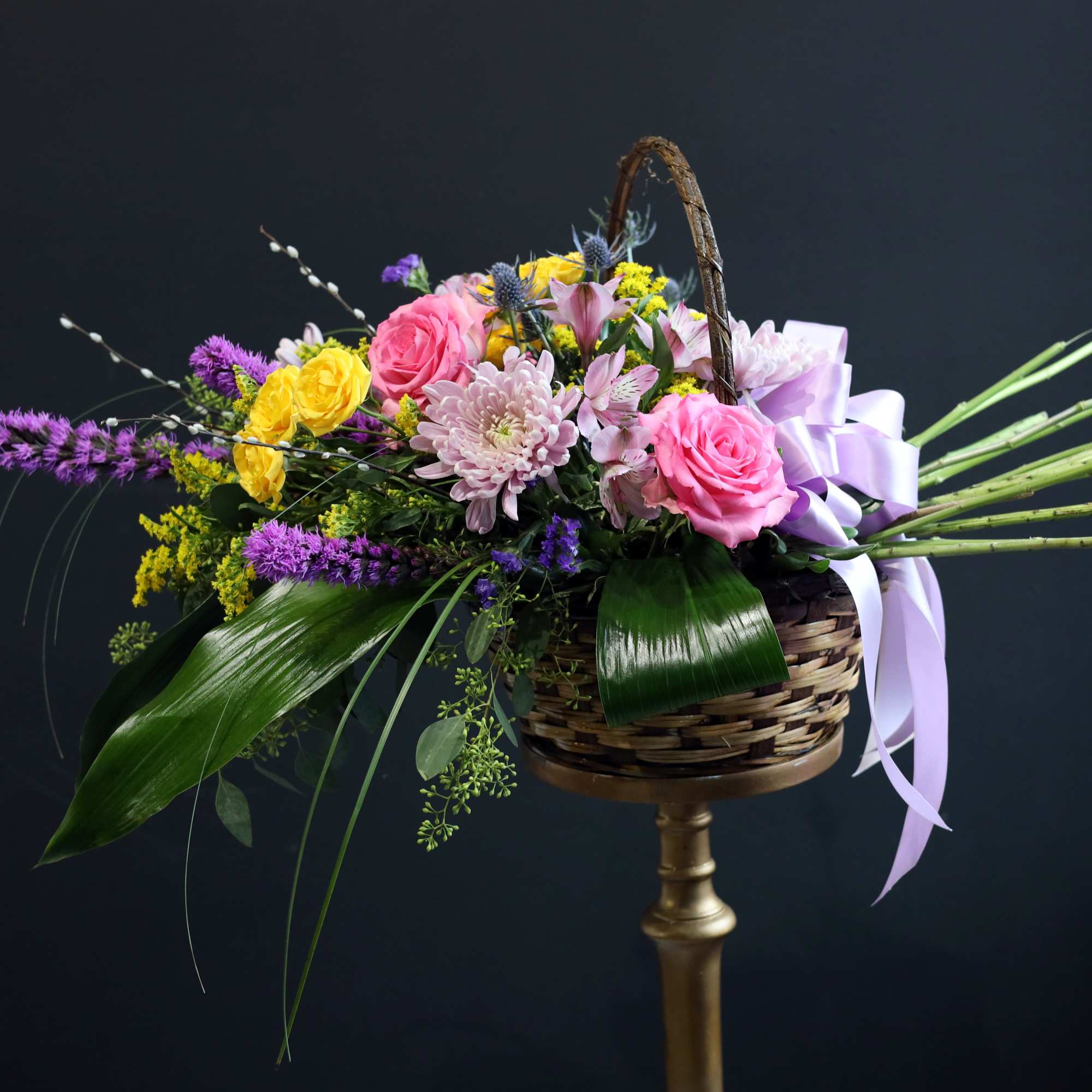 Gorgeous premium flowers filling a beautiful wicker basket designed to help a