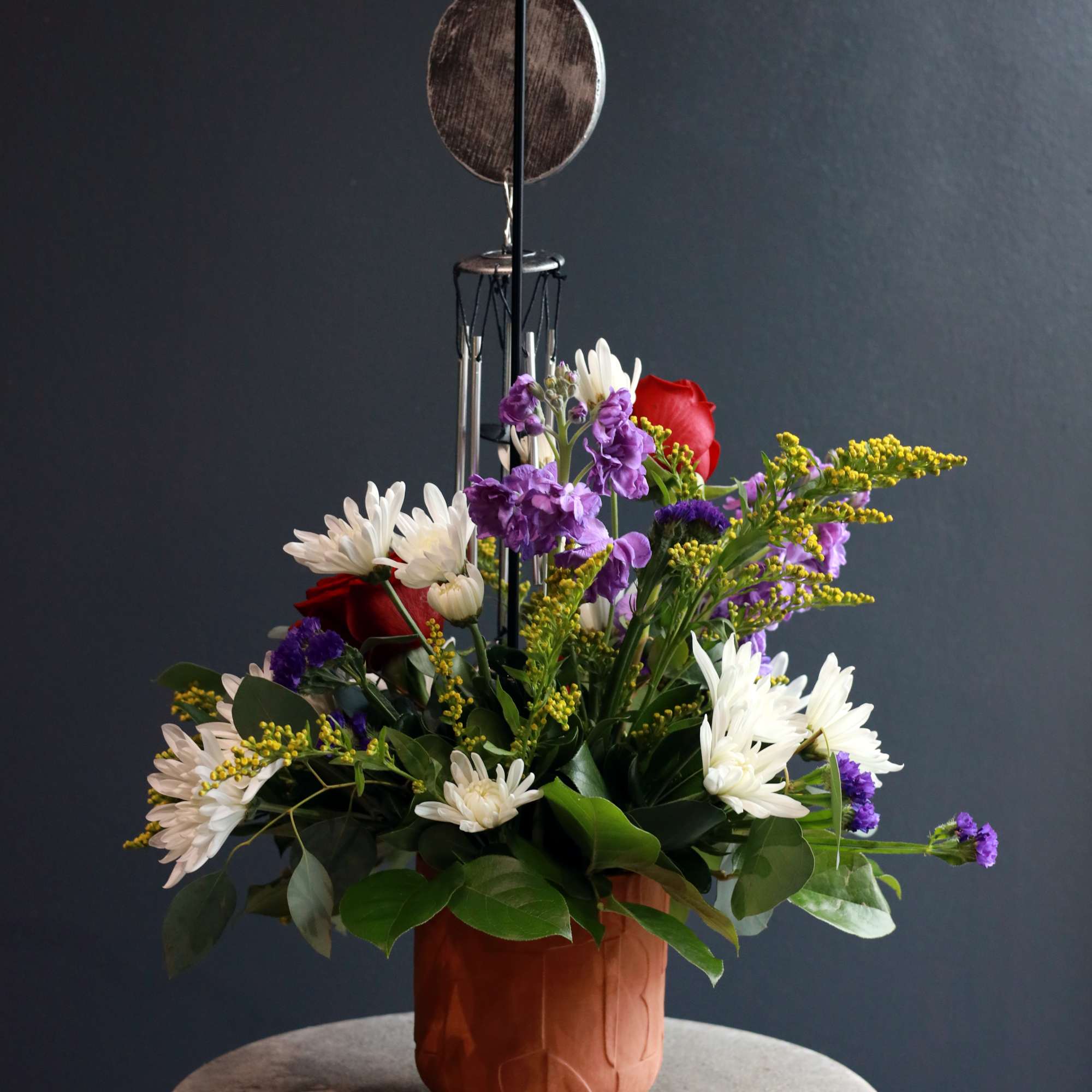 This sympathy arrangement is filled with florals of love in a terracotta