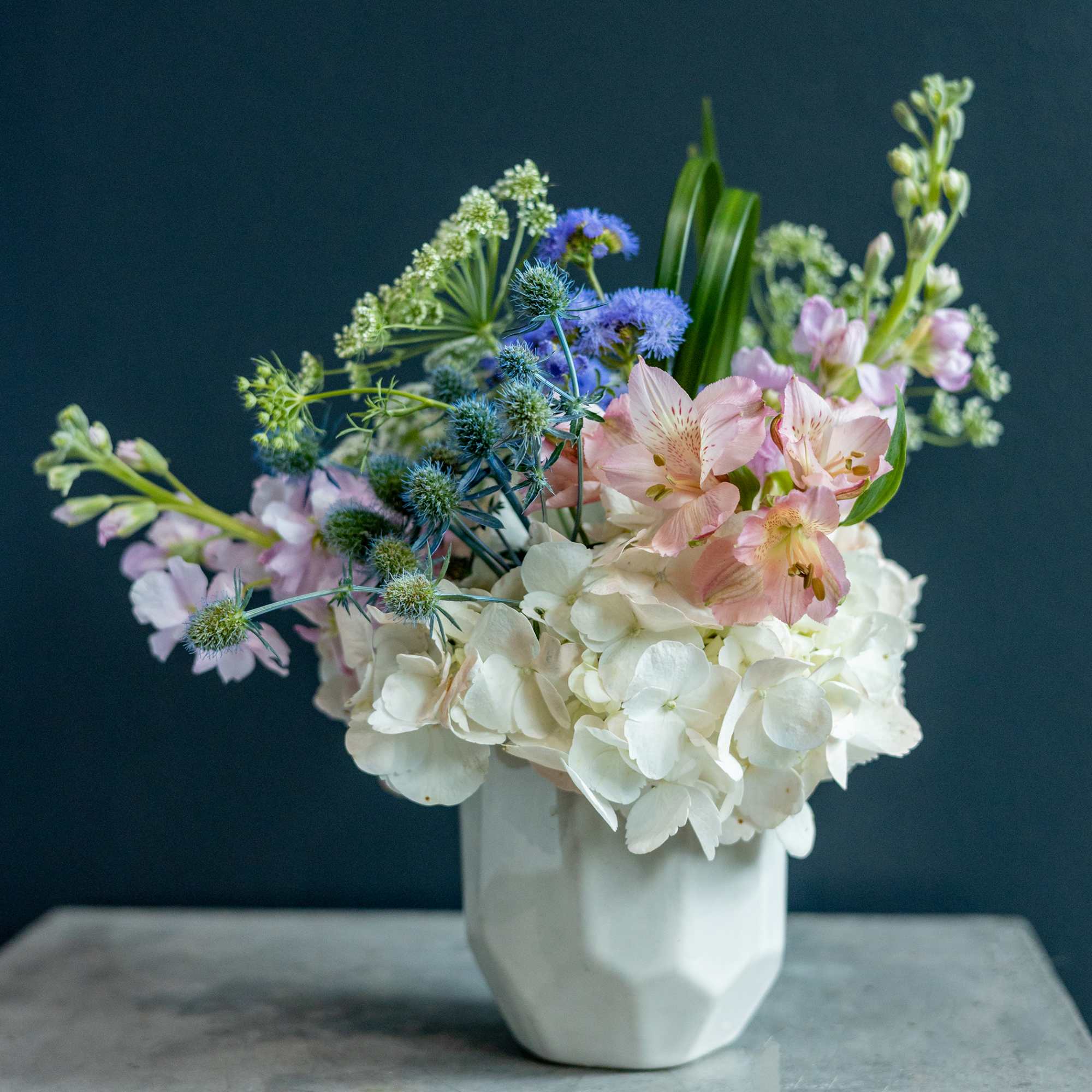 Pastel mixed bouquet in a white vase with white hydrangeas and pink alstroemeria