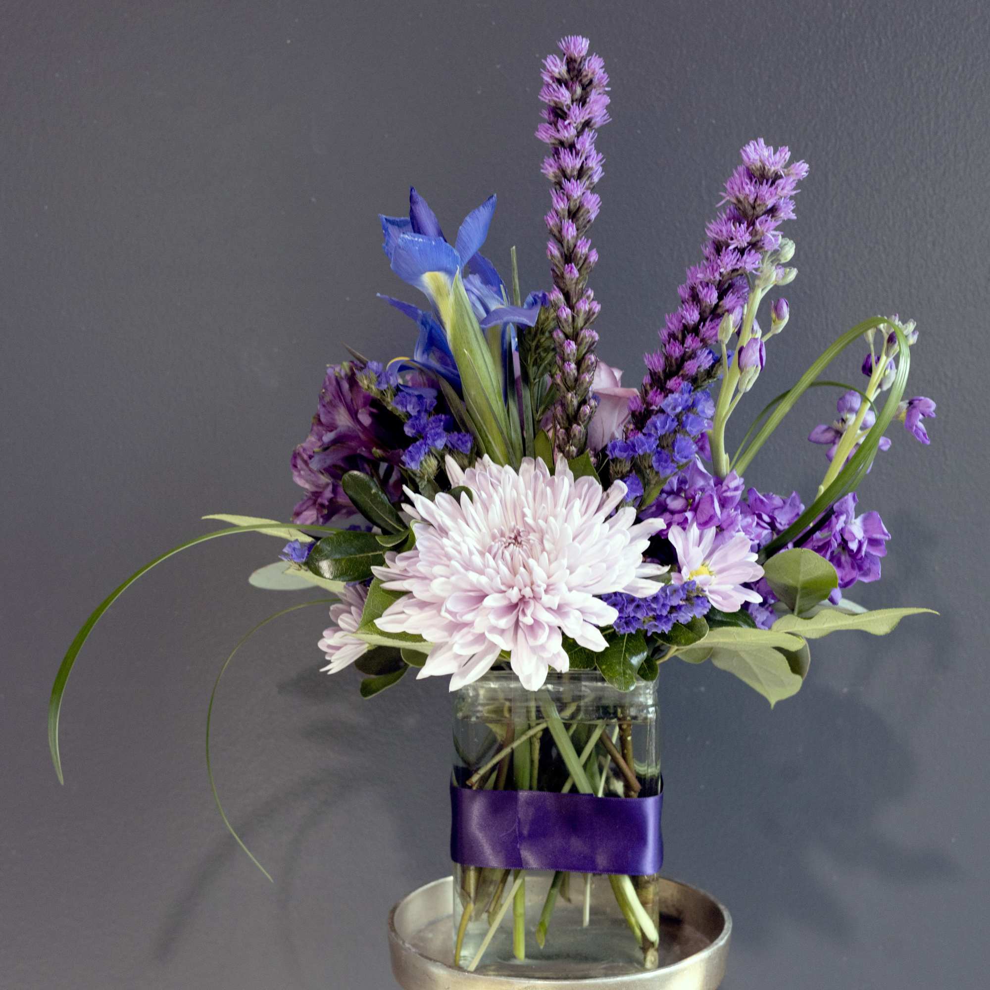 Mixture of a variety of purple florals in a glass vase decorated, photo 2 of 2