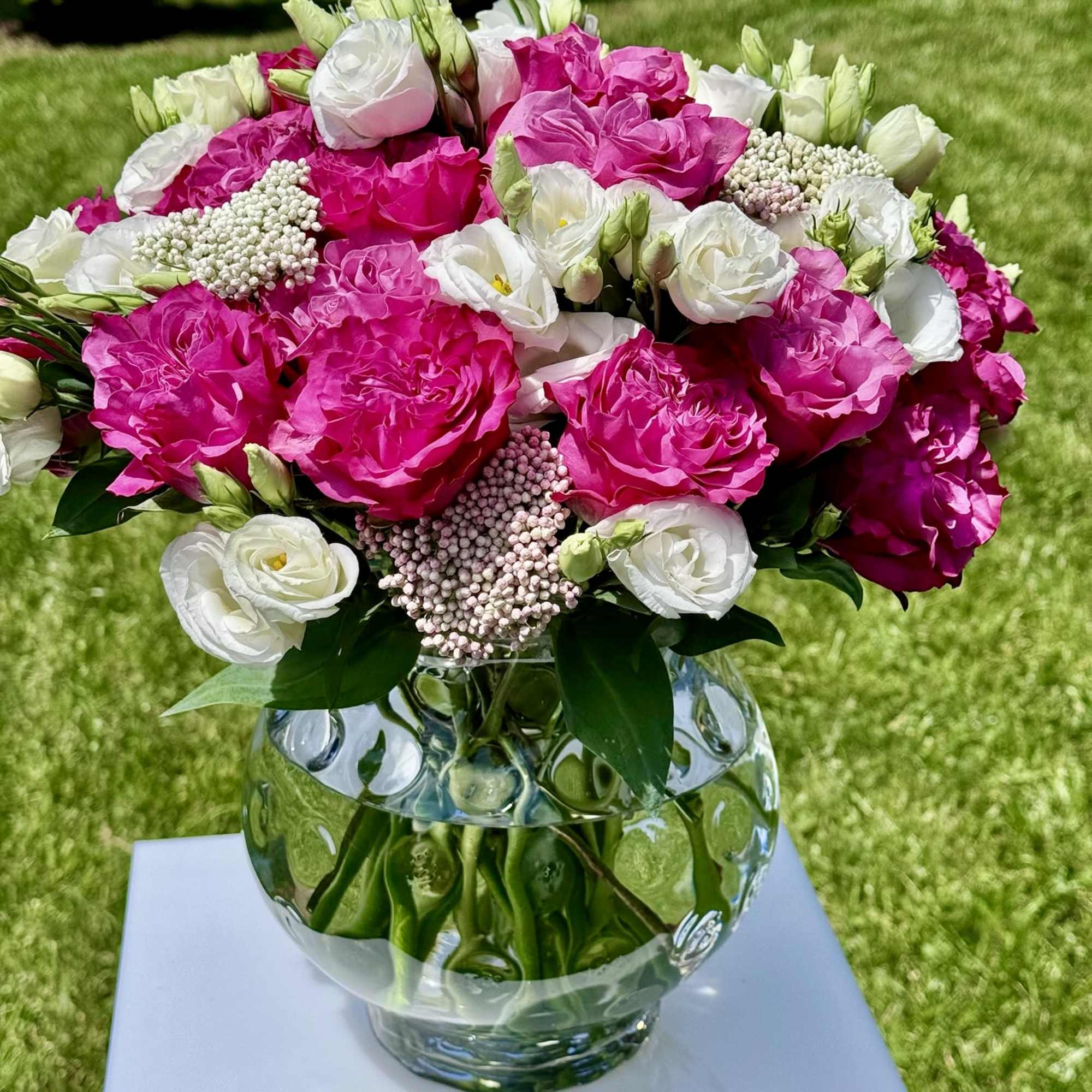 Pink and white rose bouquet in a clear glass vase