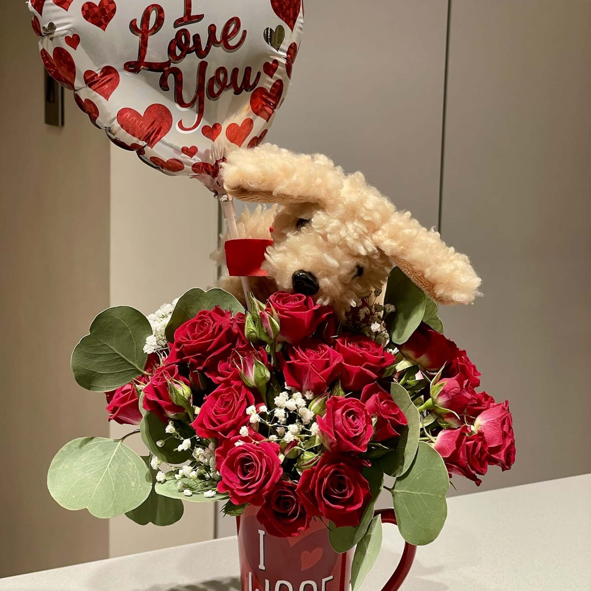 Red rose bouquet in a mug with a heart balloon and plush dog