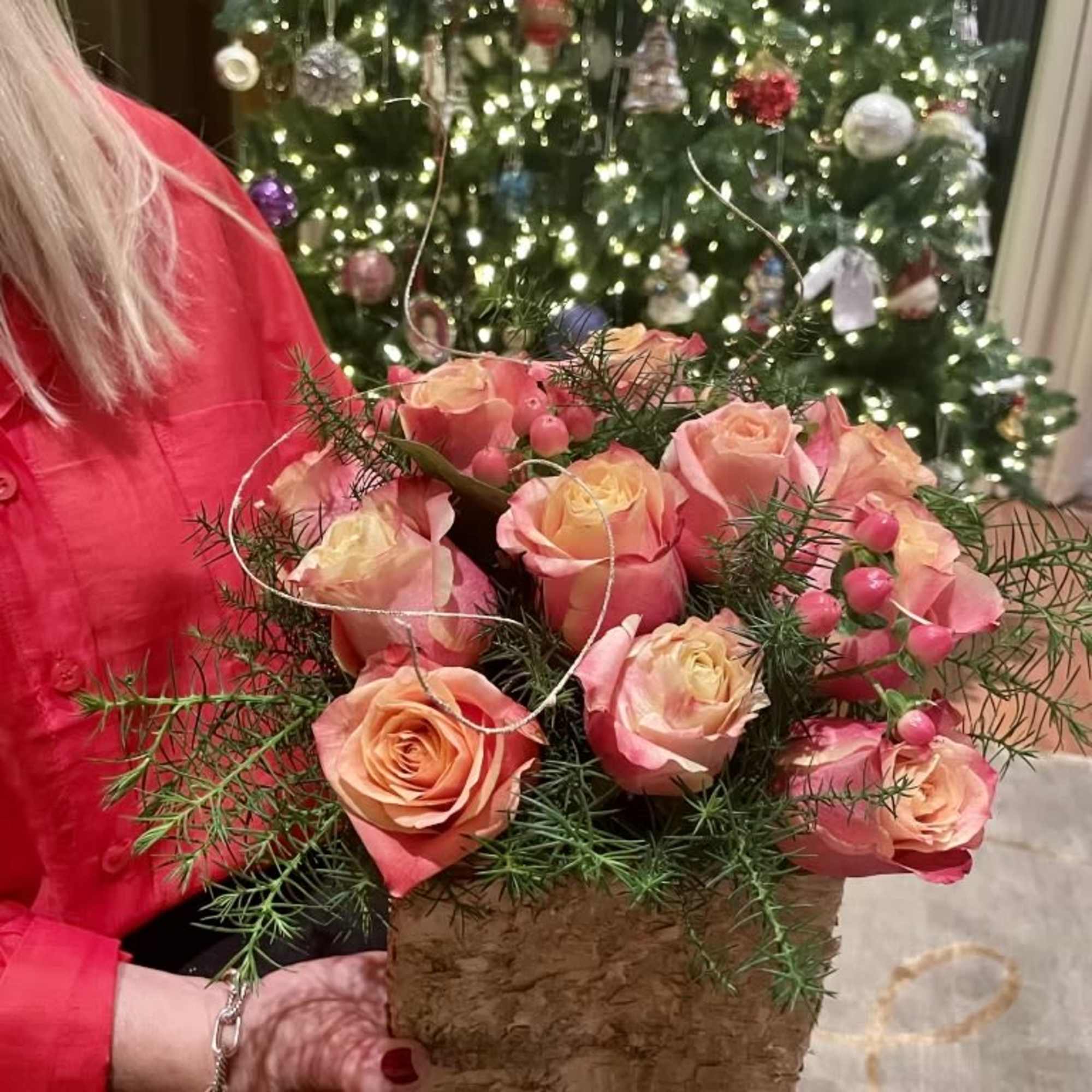 Pink roses arranged in a rustic square container