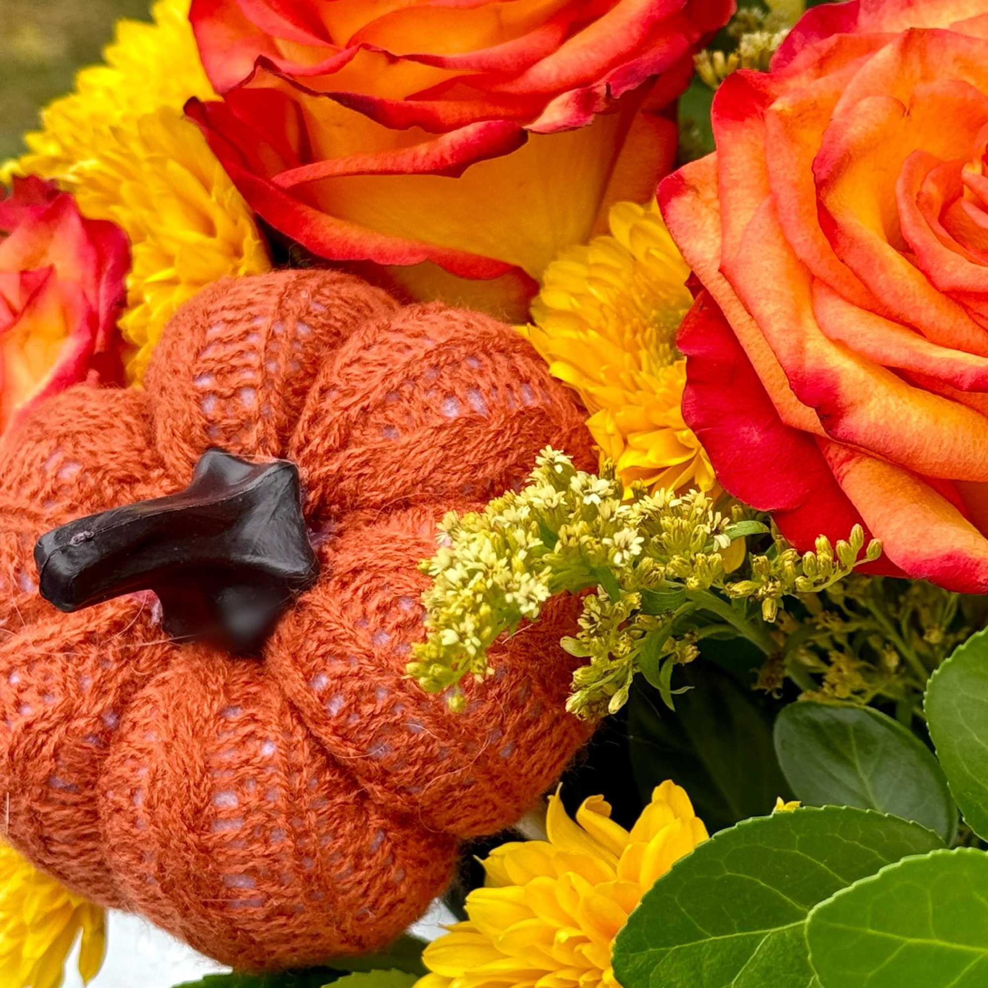 Bouquet with orange roses, yellow mums, and a small pumpkin decoration