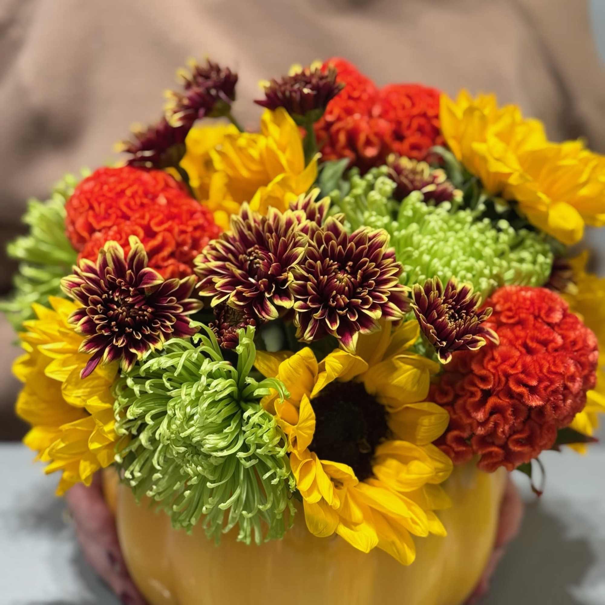 Mixed flowers arranged in a pumpkin-shaped container