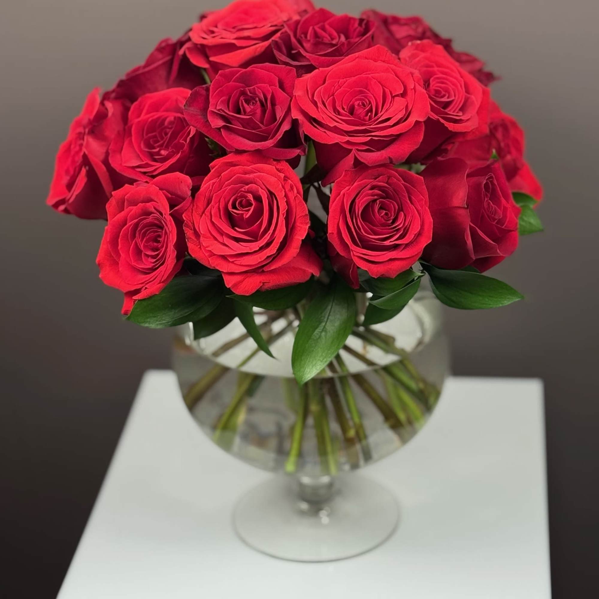 Bouquet of red roses in a clear glass vase
