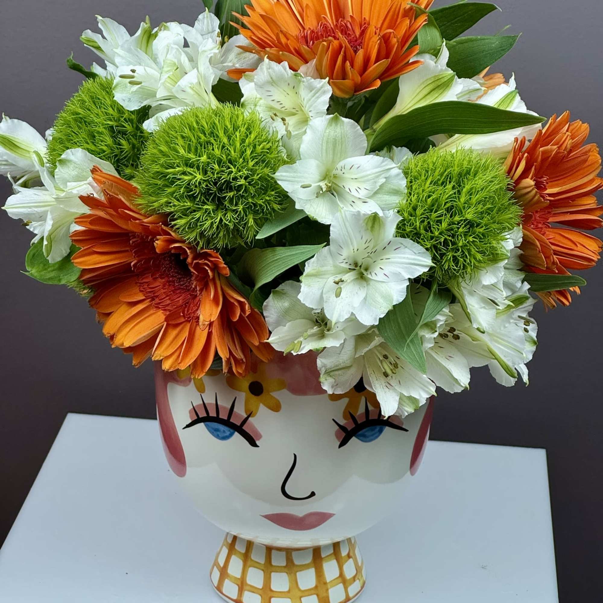 This cheerful arrangement is designed to bring a playful burst of personality