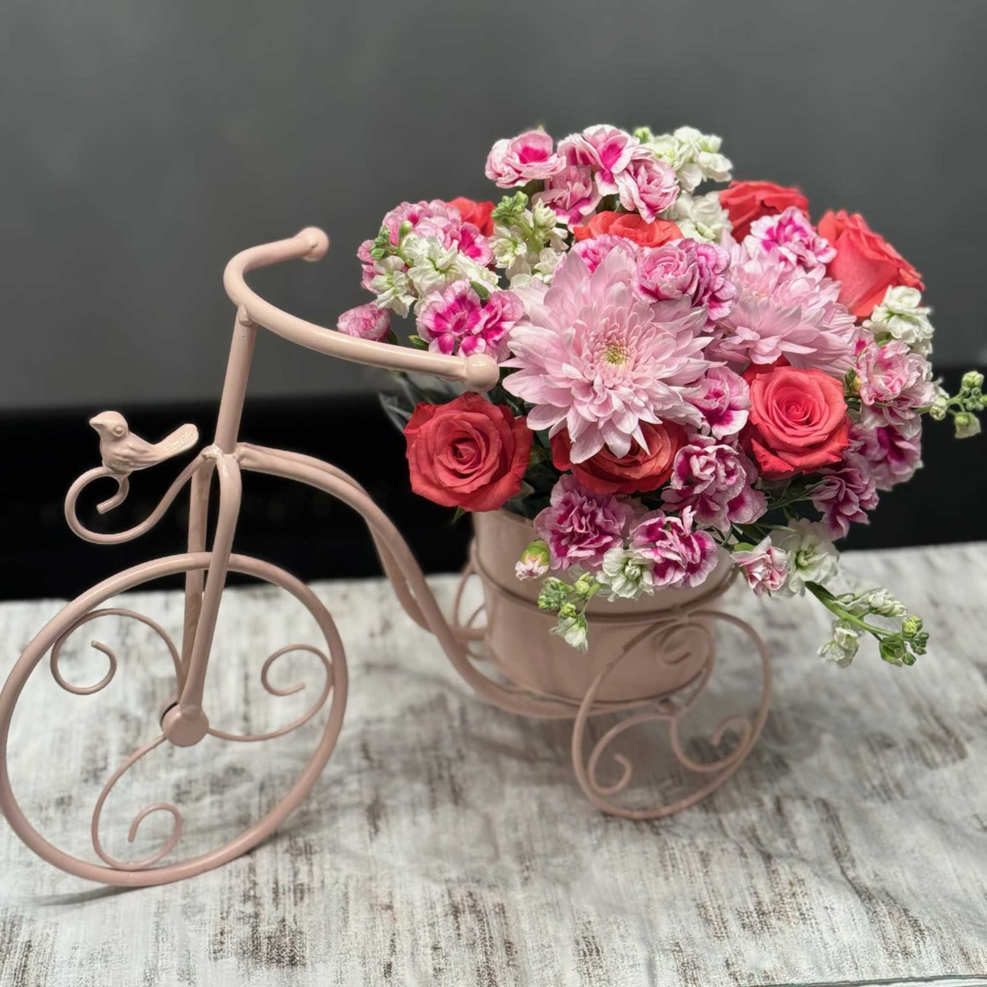 This charming, vintage-inspired arrangement is a masterclass in texture and color, blending