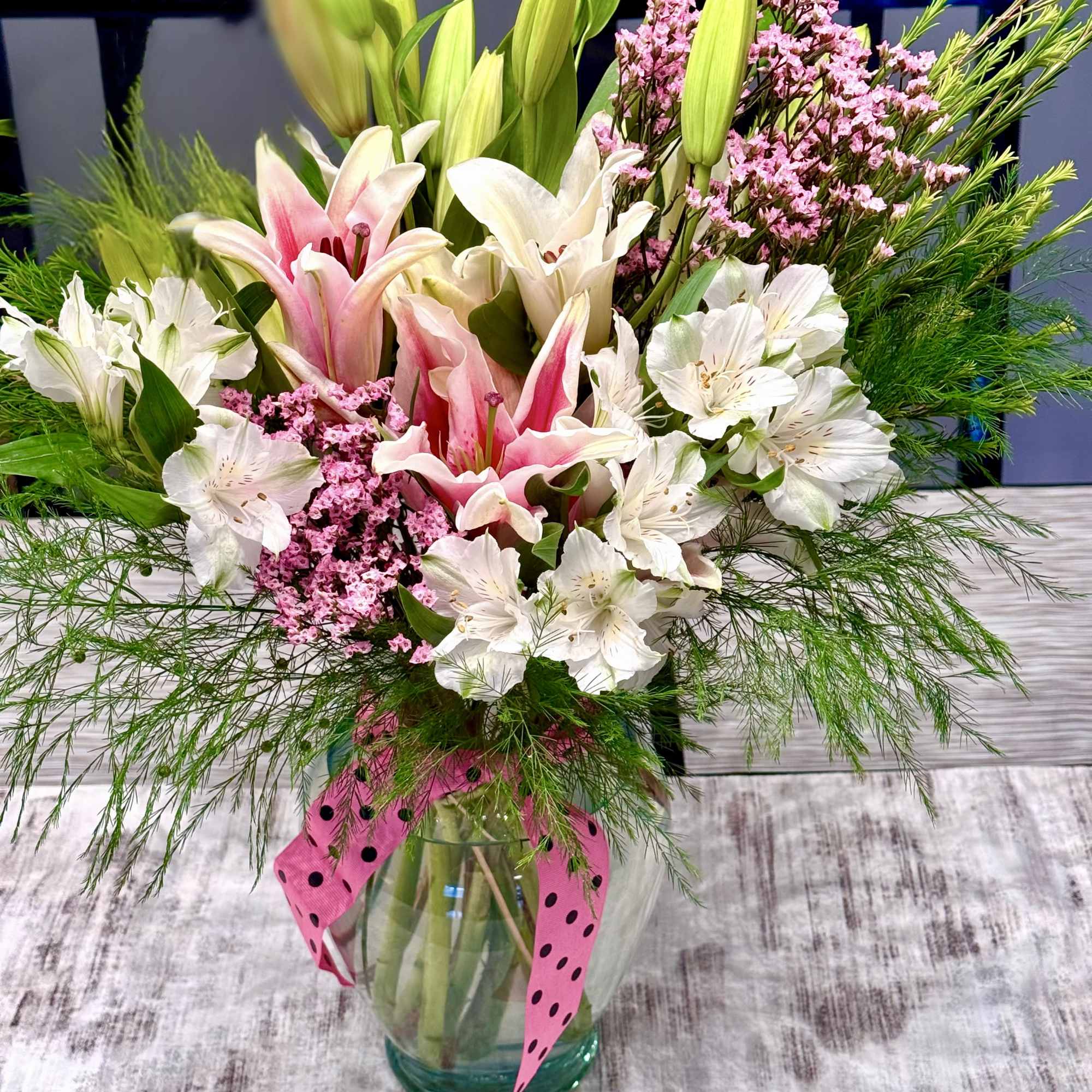 The bouquet features premium flowers in various shades, each carefully chosen for