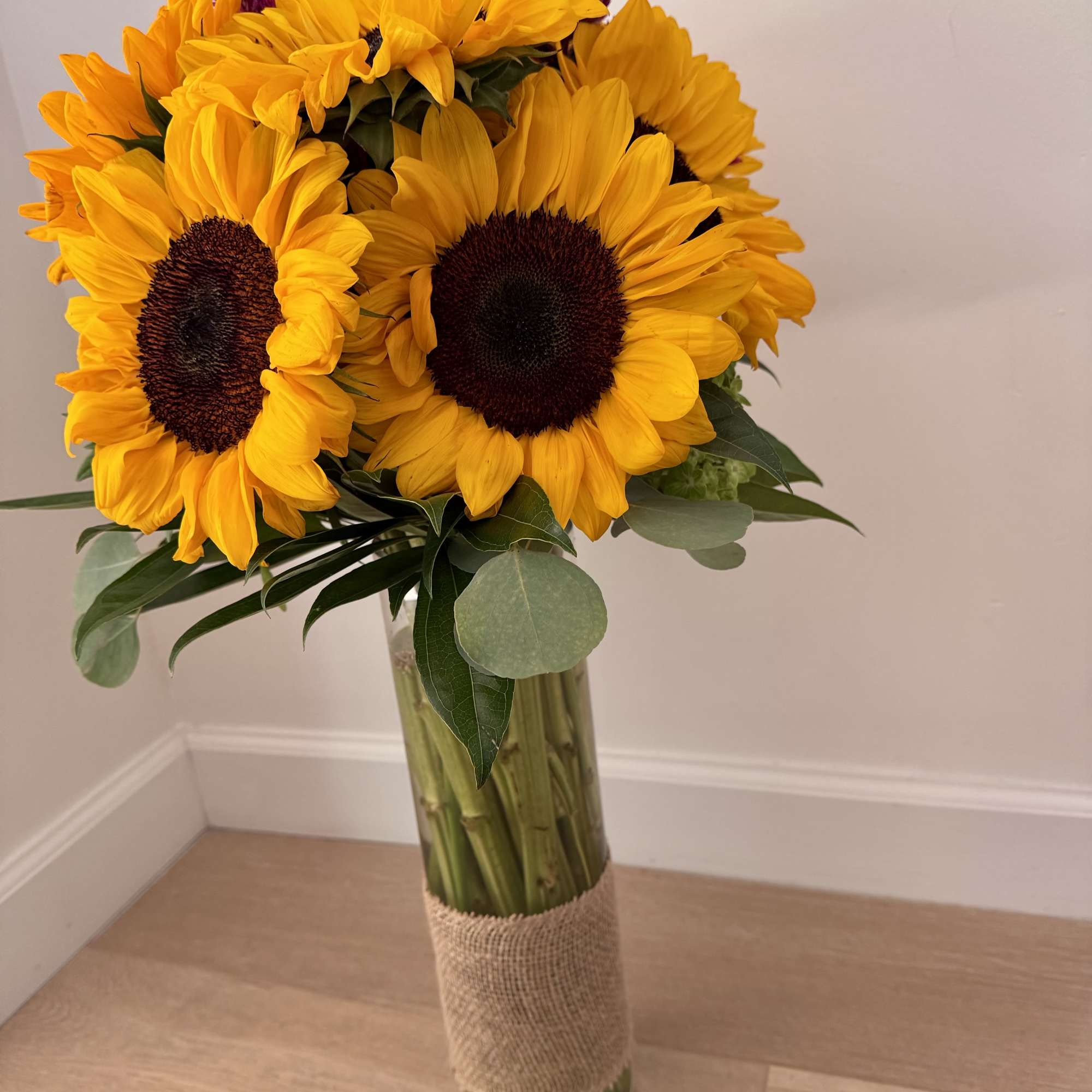 A radiant display of sunflowers designed to brighten any space. This arrangement