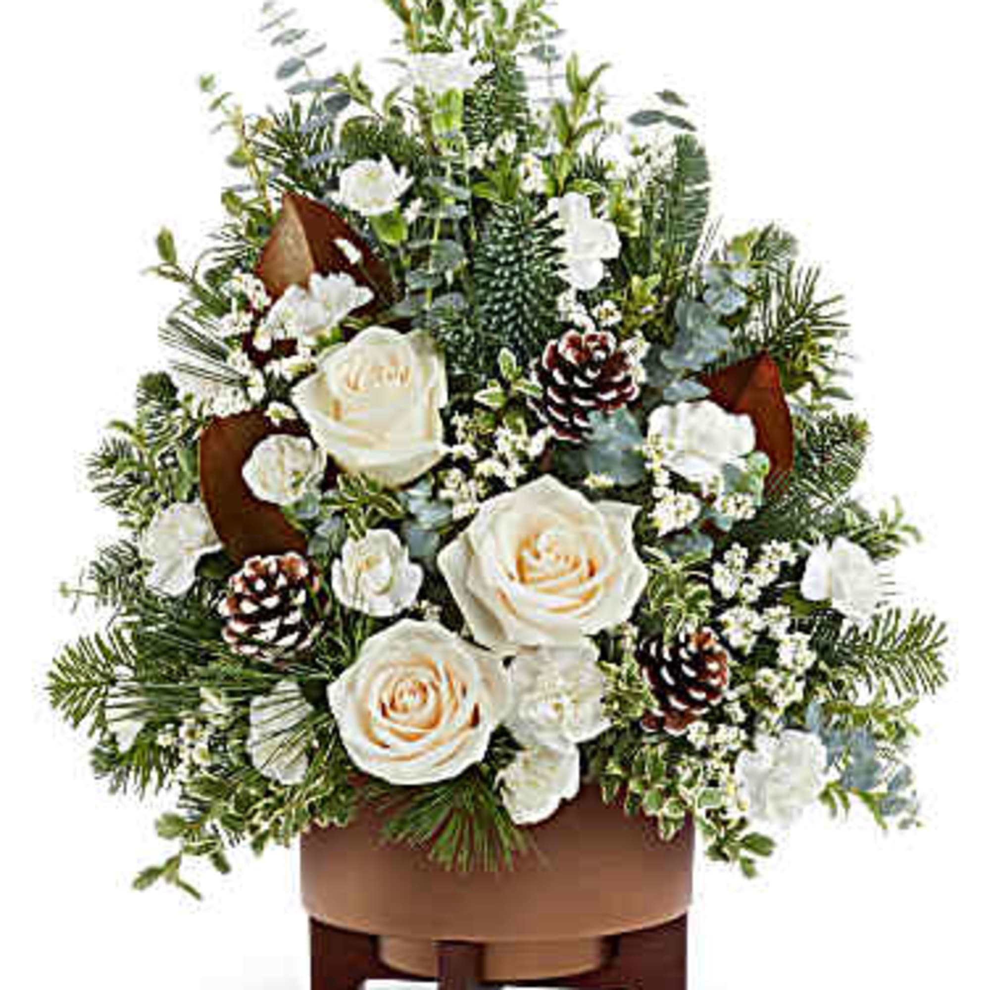 White roses and pinecones in a brown container