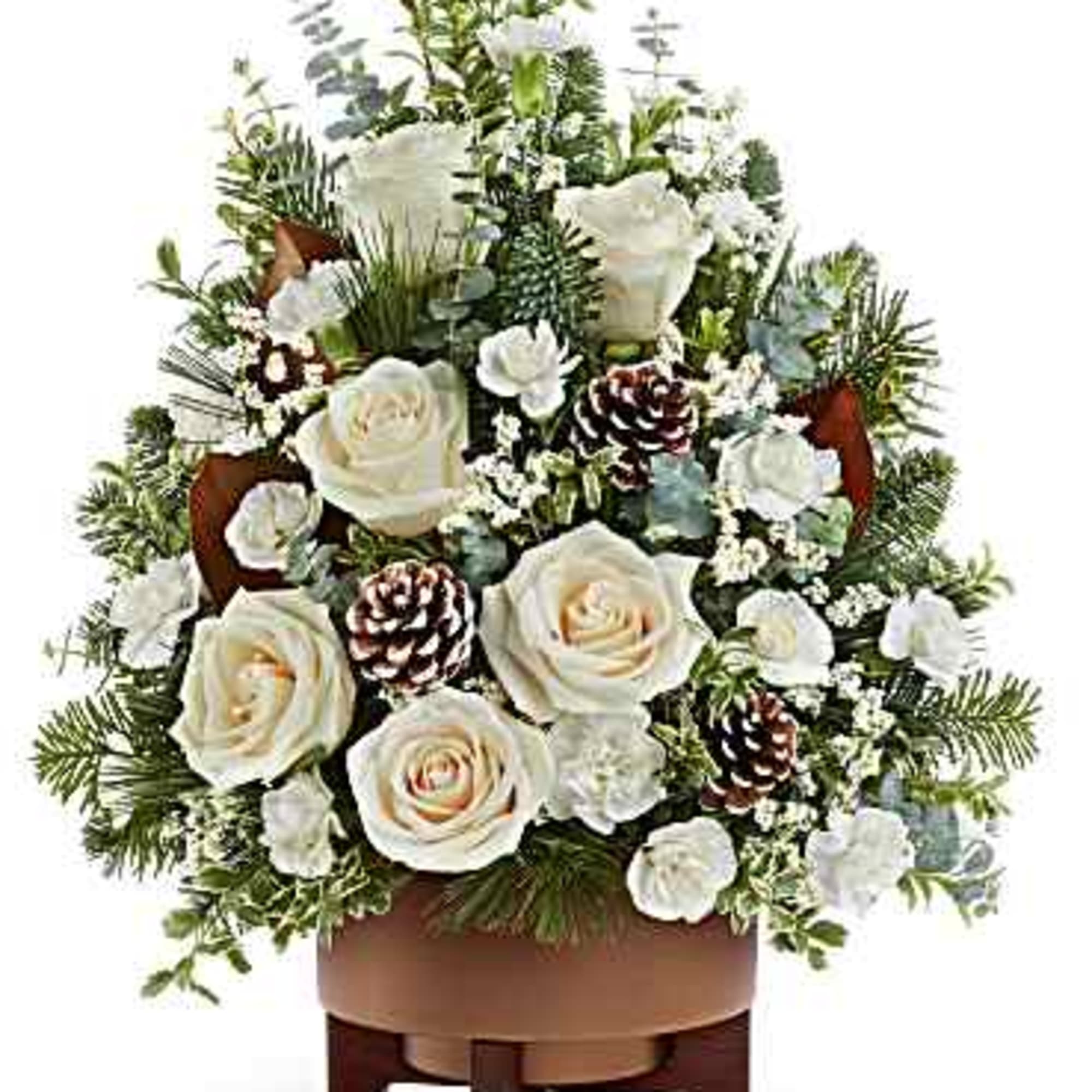 White roses and pinecones in a low wooden container