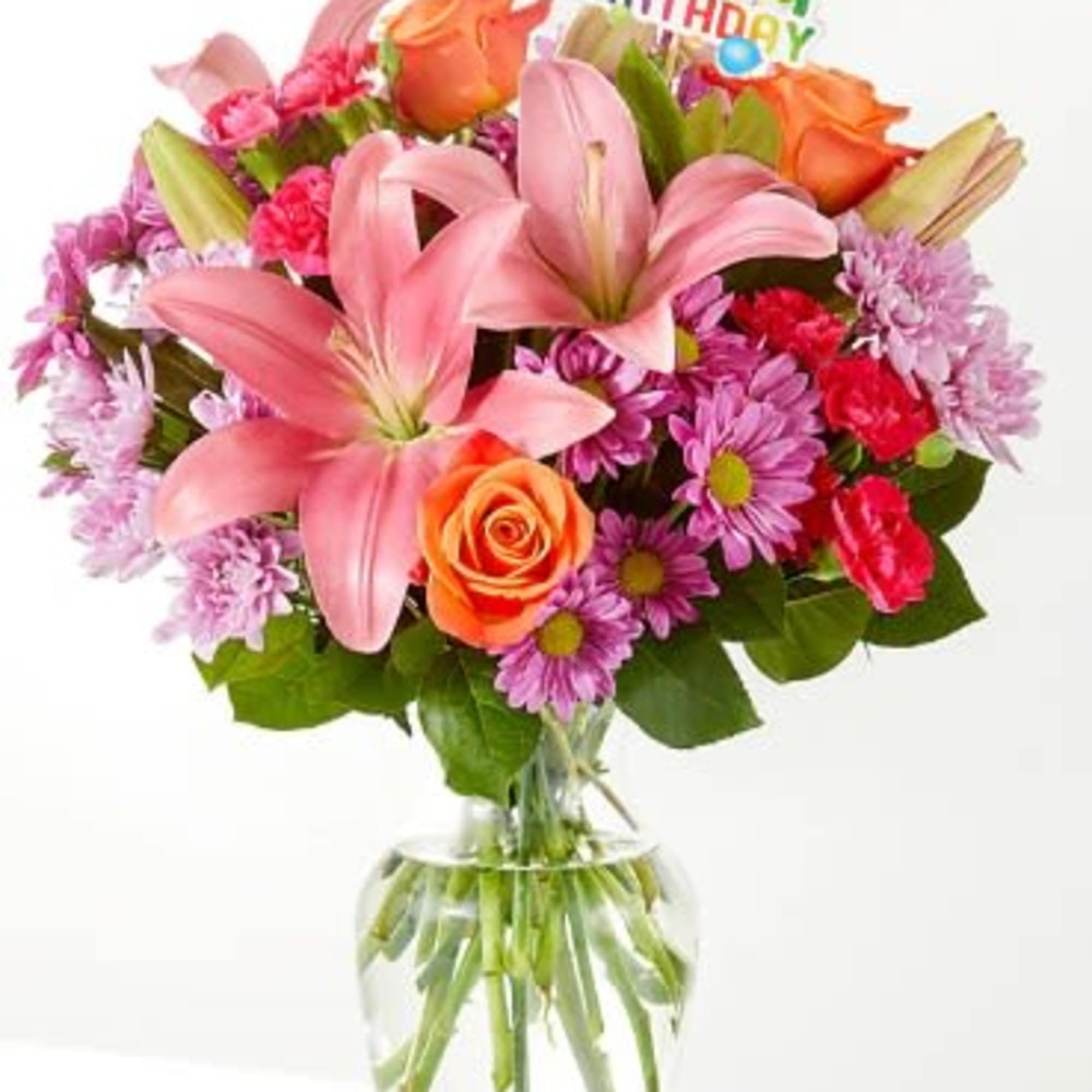 Colorful birthday bouquet with lilies, roses, and daisies in a glass vase