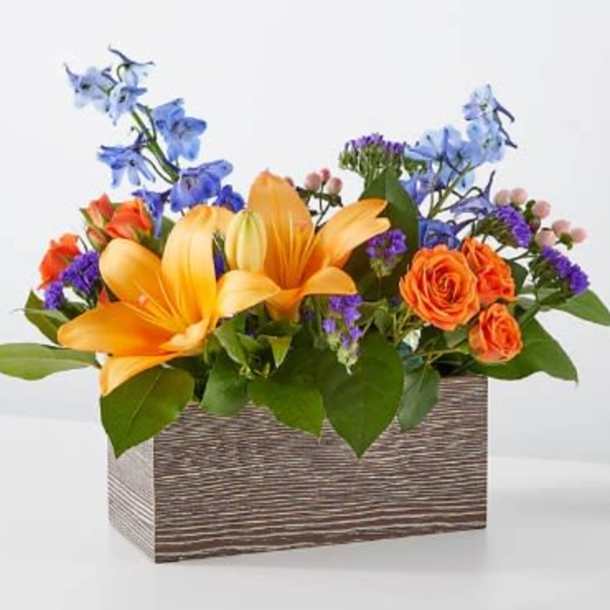 Orange lilies and roses in a rectangular wooden box