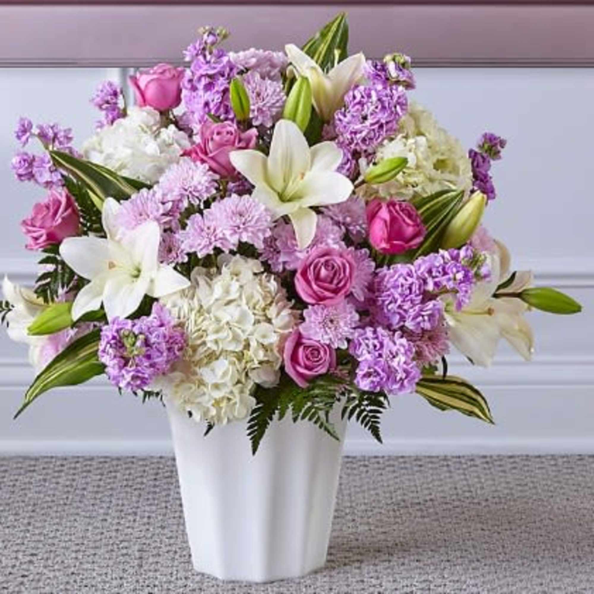 Pink and white floral arrangement in a white vase