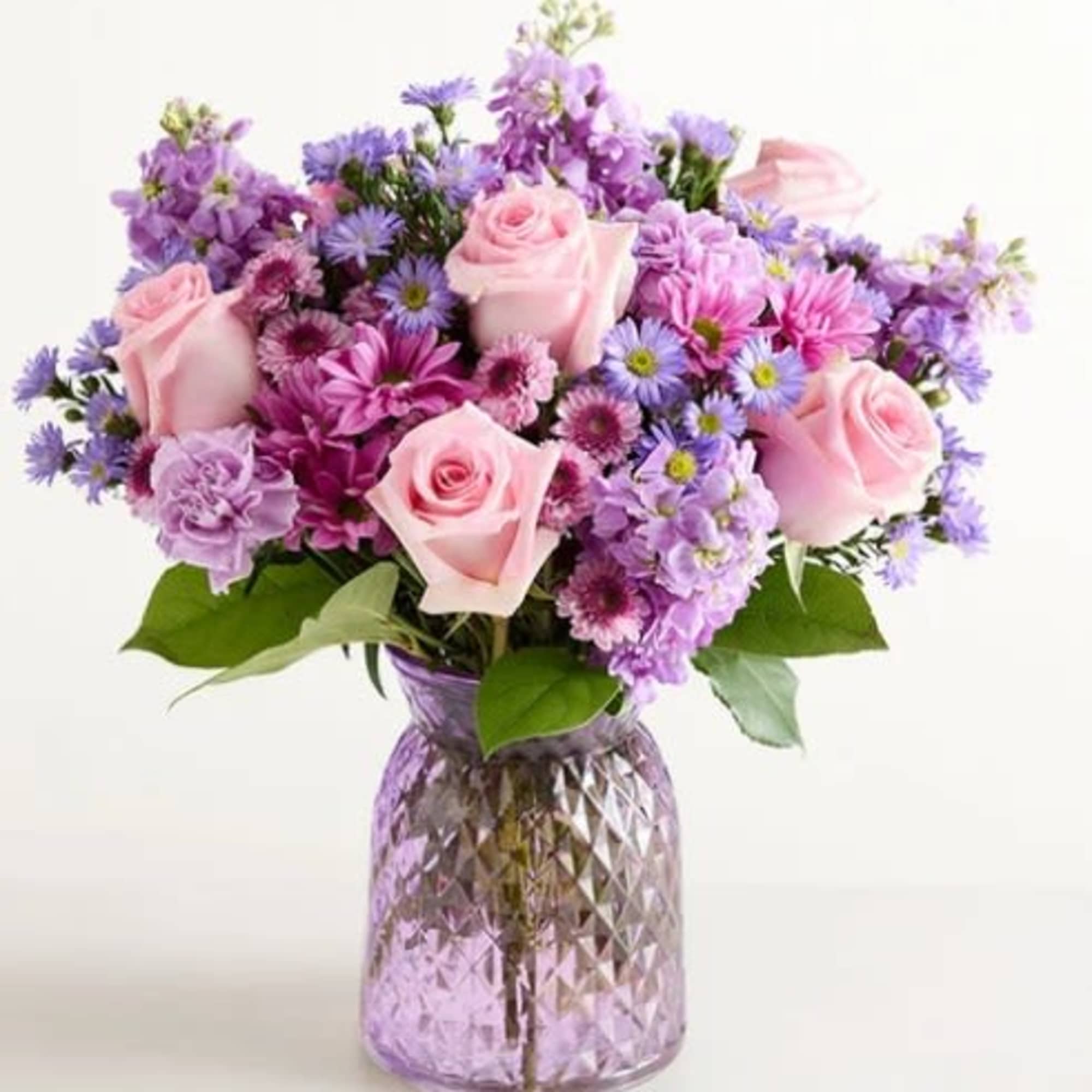 Soft pink roses with lavender and purple daisies, carnations, asters and mums