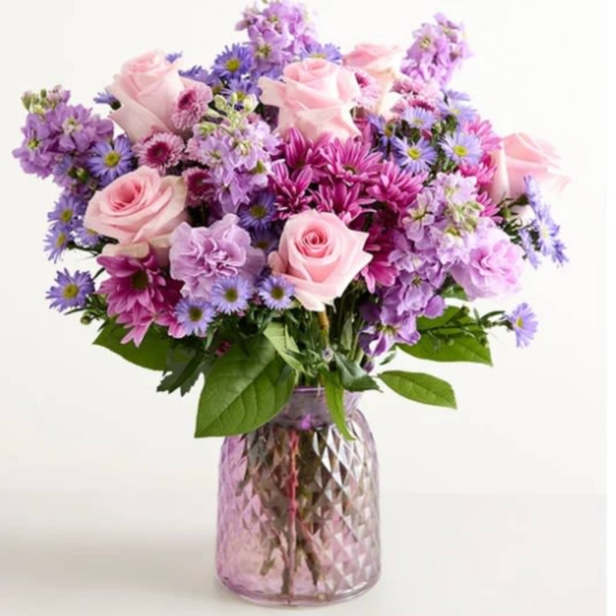Soft pink roses with lavender and purple daisies, carnations, asters and mums