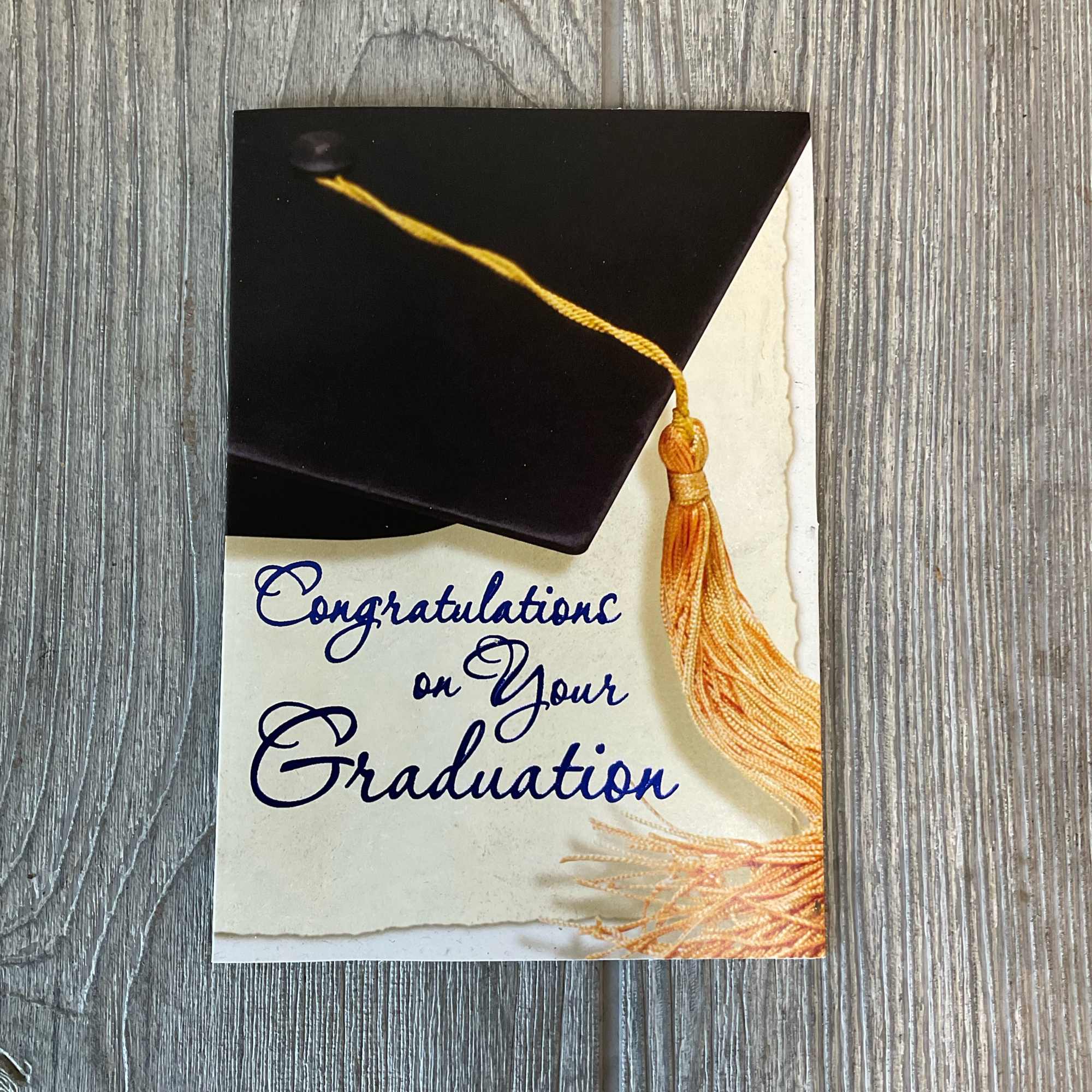 Graduation card with a black mortarboard and gold tassel