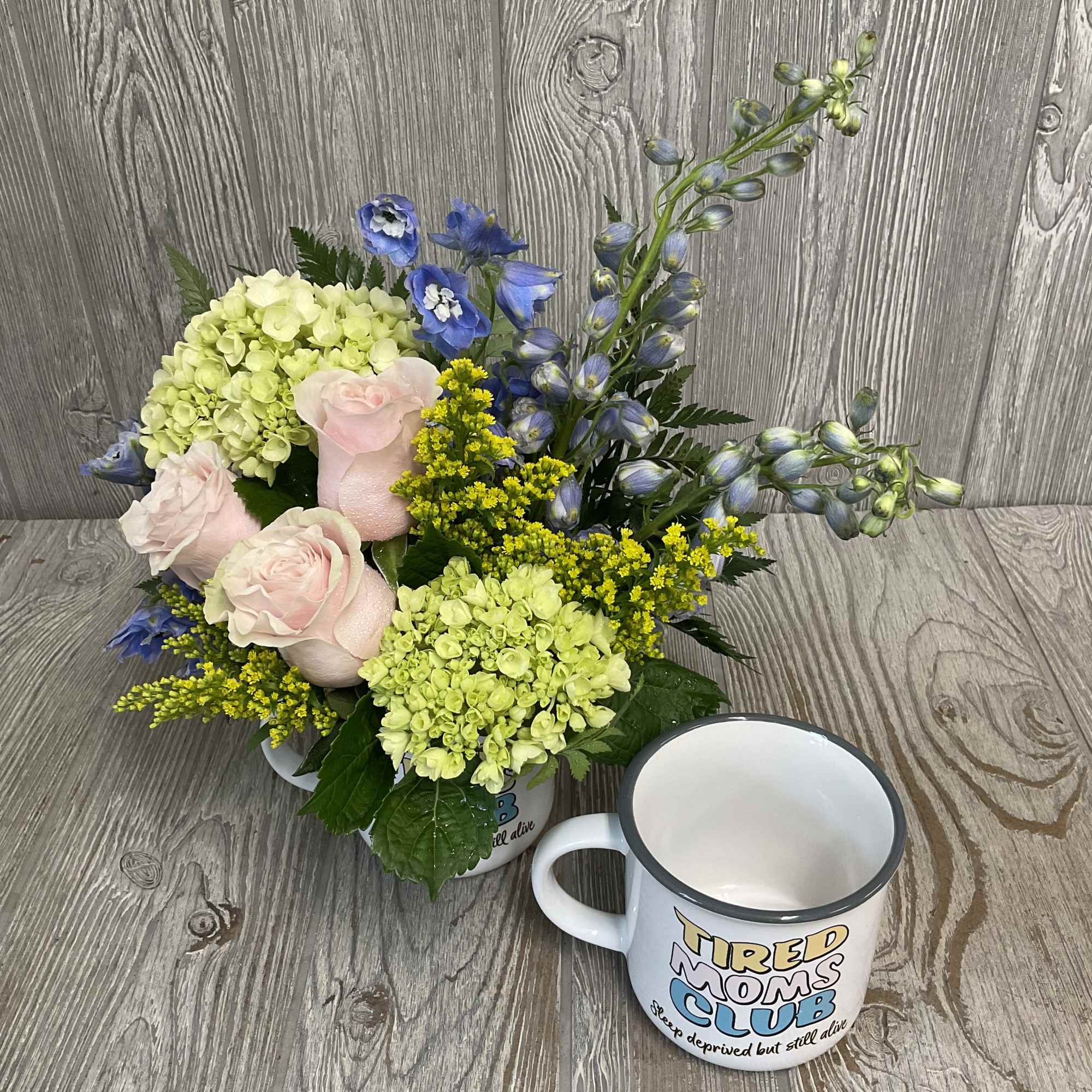 A soft floral arrangement in a relatable keepsake mug. Makes a great