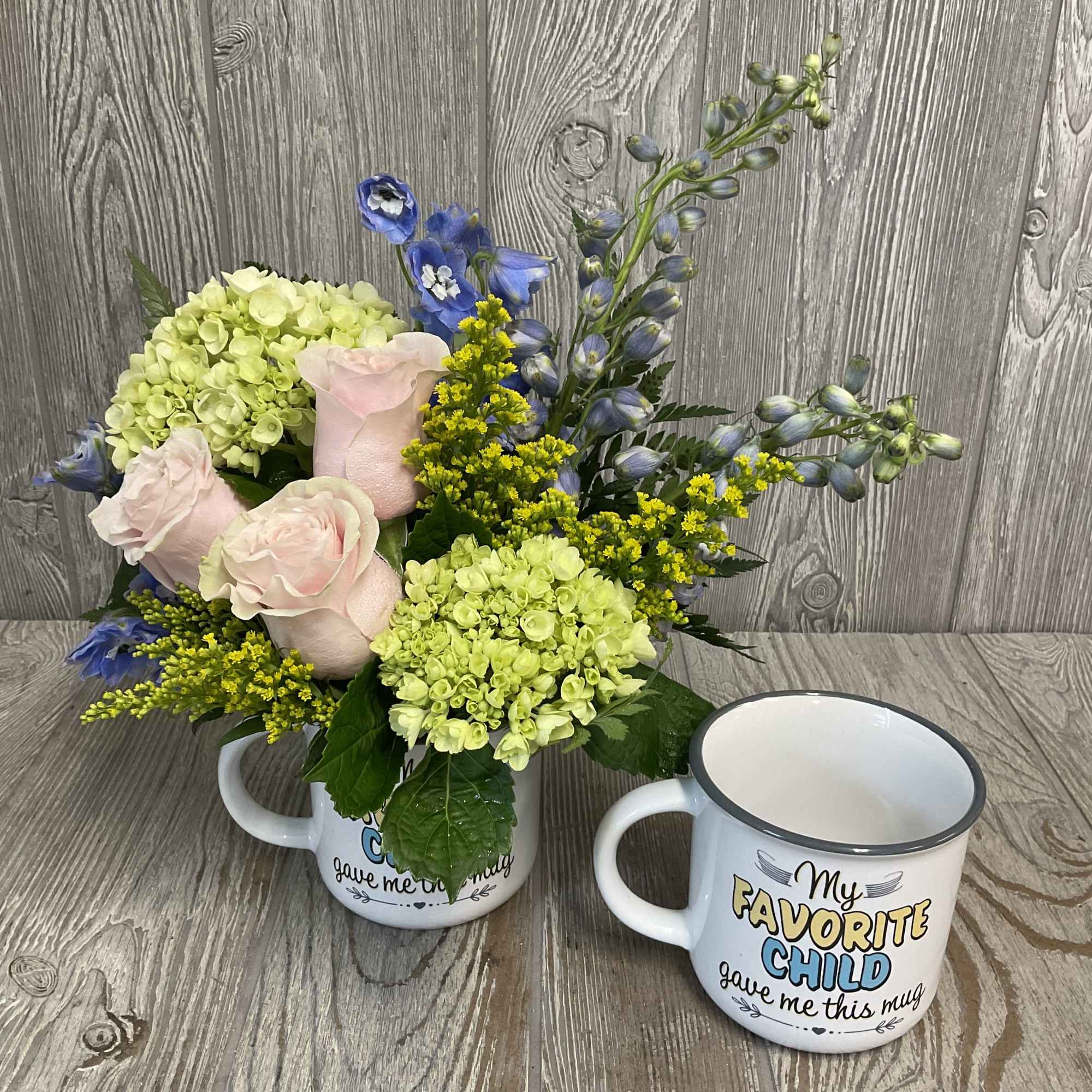 A soft floral arrangement in a funny keepsake mug - a perfect