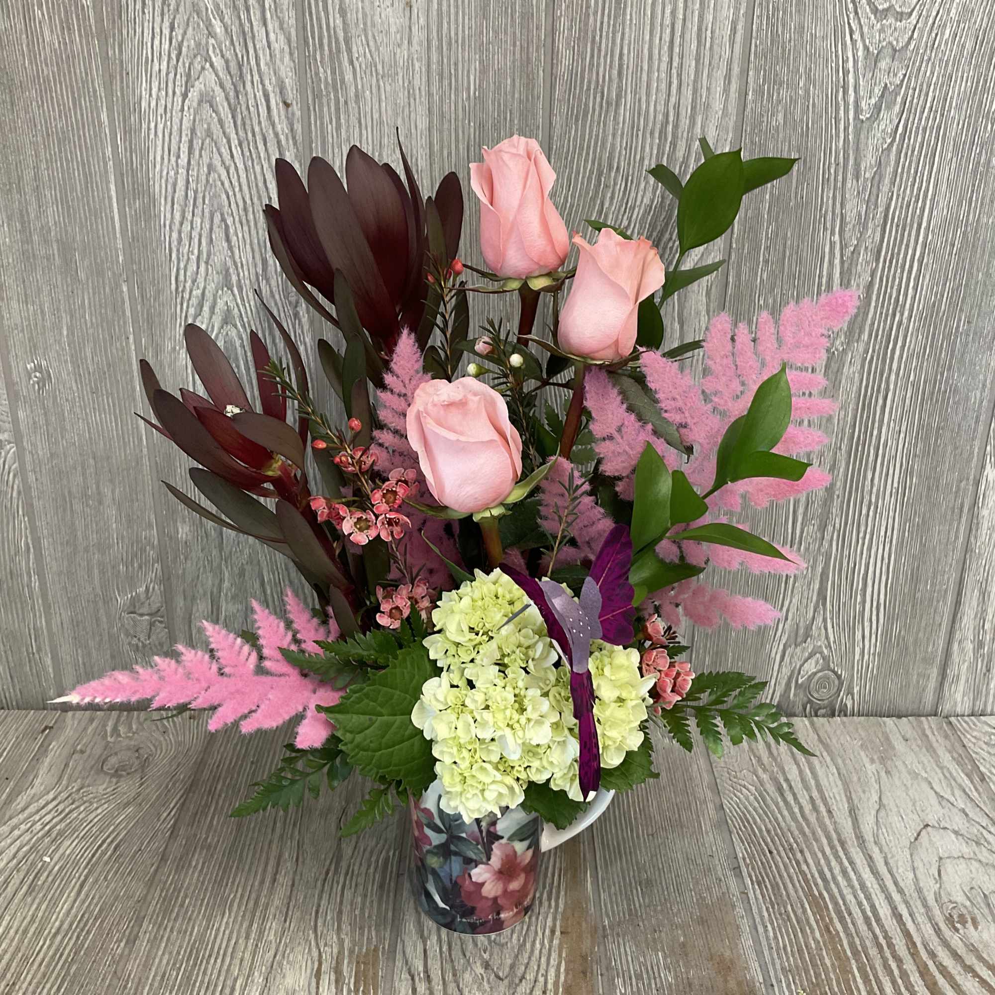A modern style fresh cut flower arrangement, in a keepsake ceramic hummingbird, photo 2 of 3