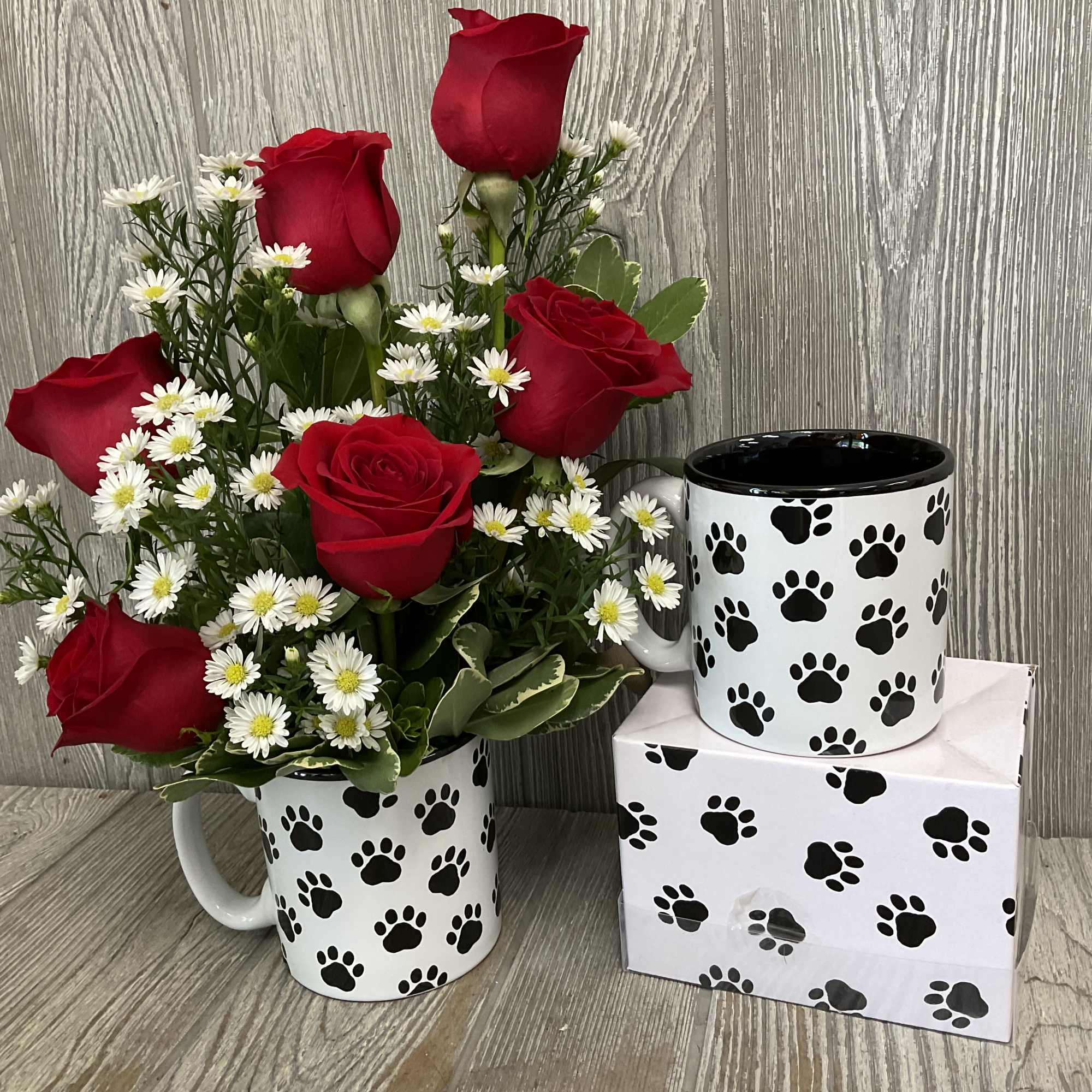 Red roses and white daisies in a paw-print mug with a matching mug and box