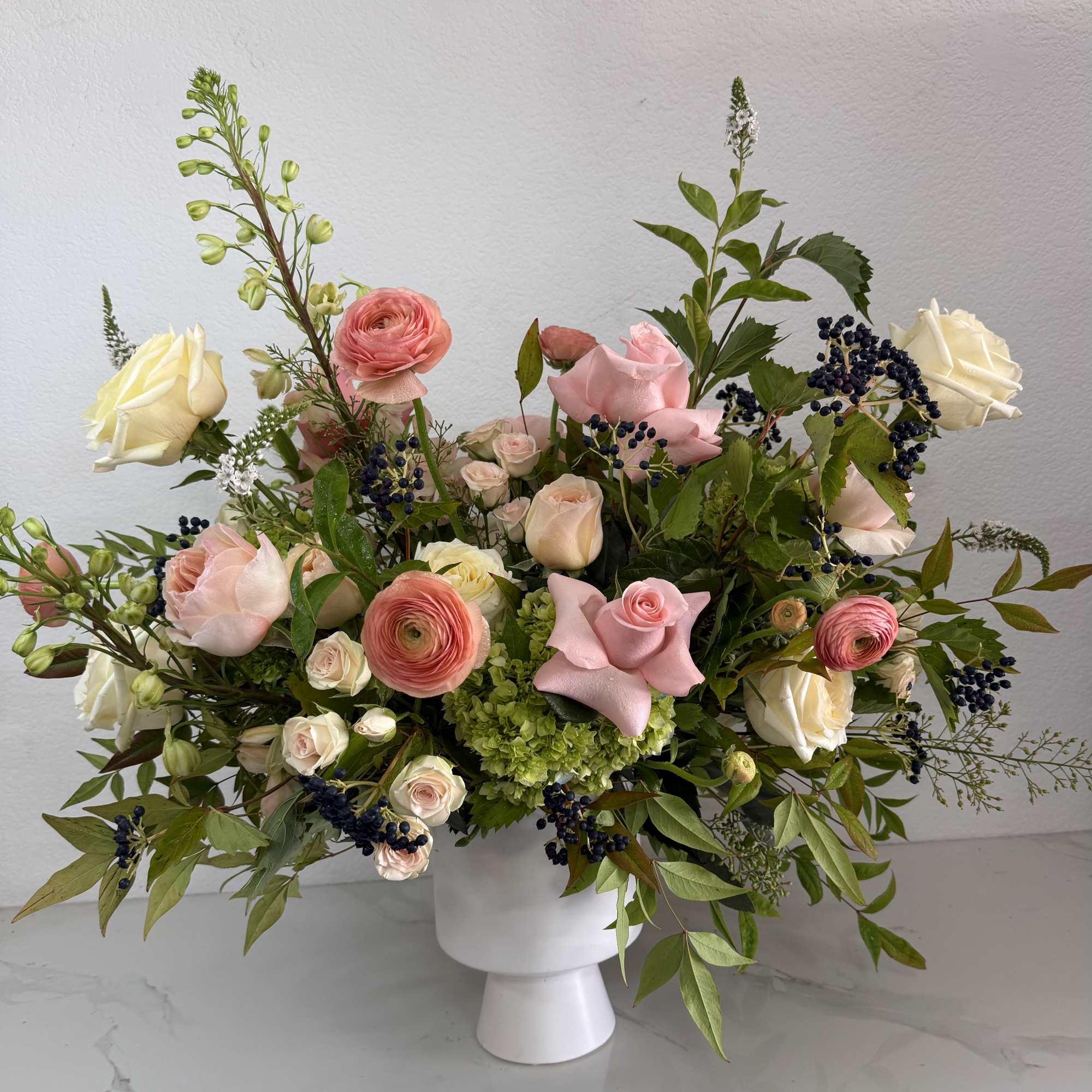 Pink and cream roses with ranunculus in a white vase, photo 2 of 2