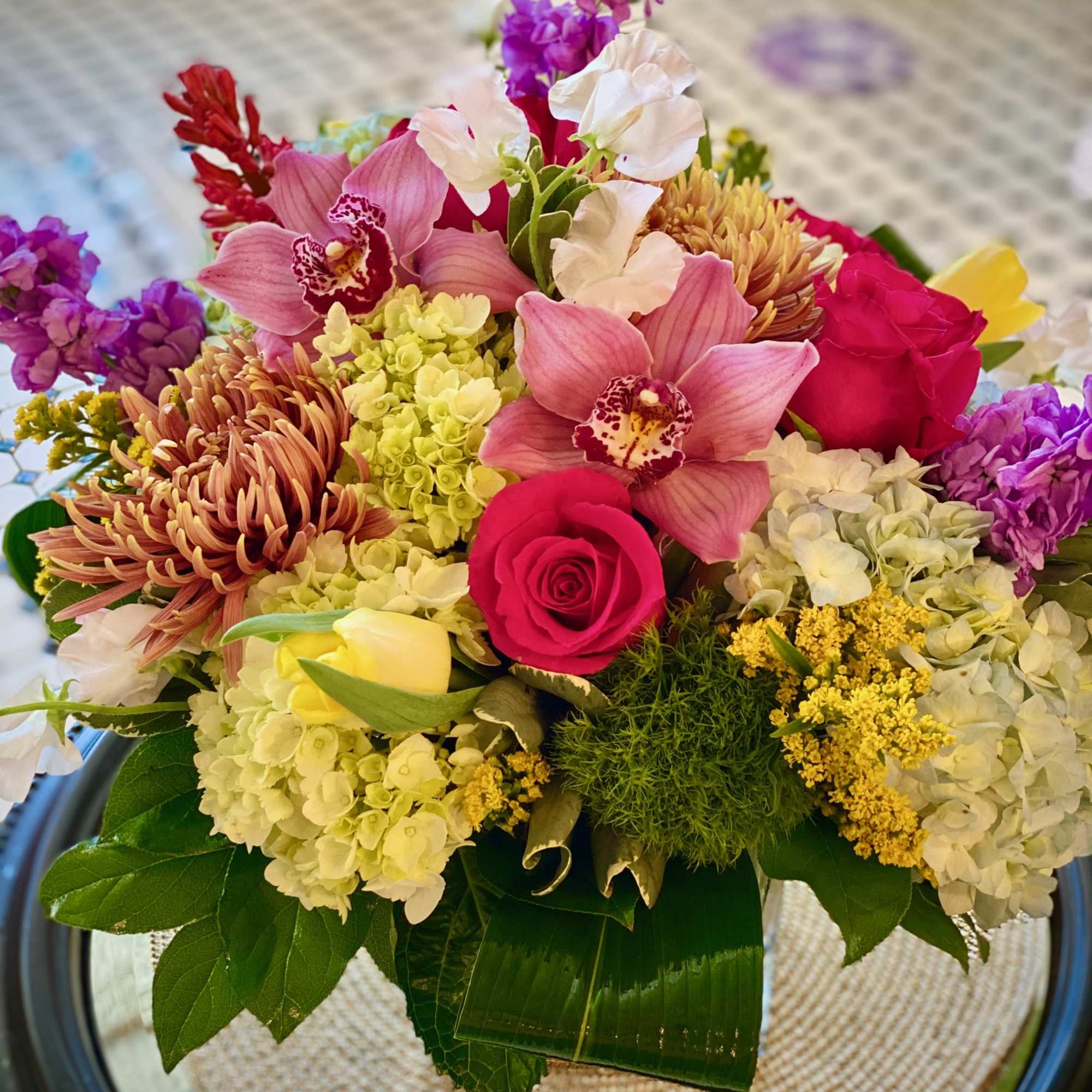 Mixed bouquet with pink orchids, roses, hydrangeas, and chrysanthemums