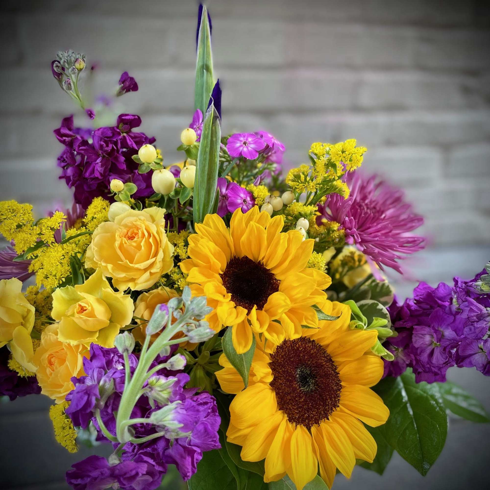 Bouquet with sunflowers, yellow roses, and purple flowers