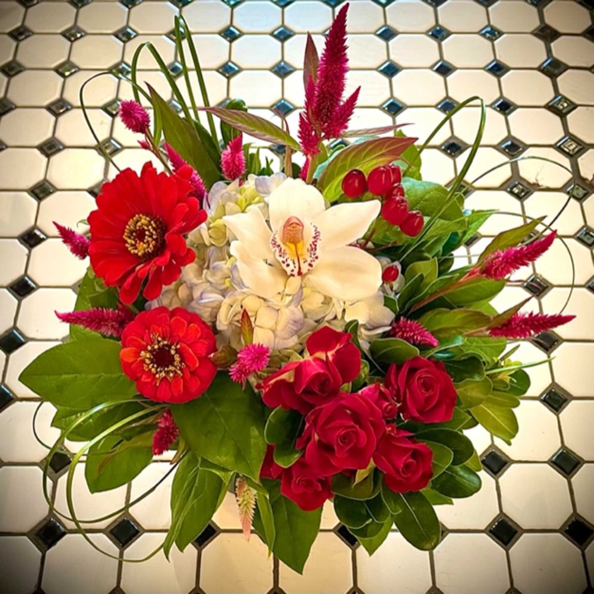 Bouquet of red roses, red zinnias, white orchid, and pink spikes