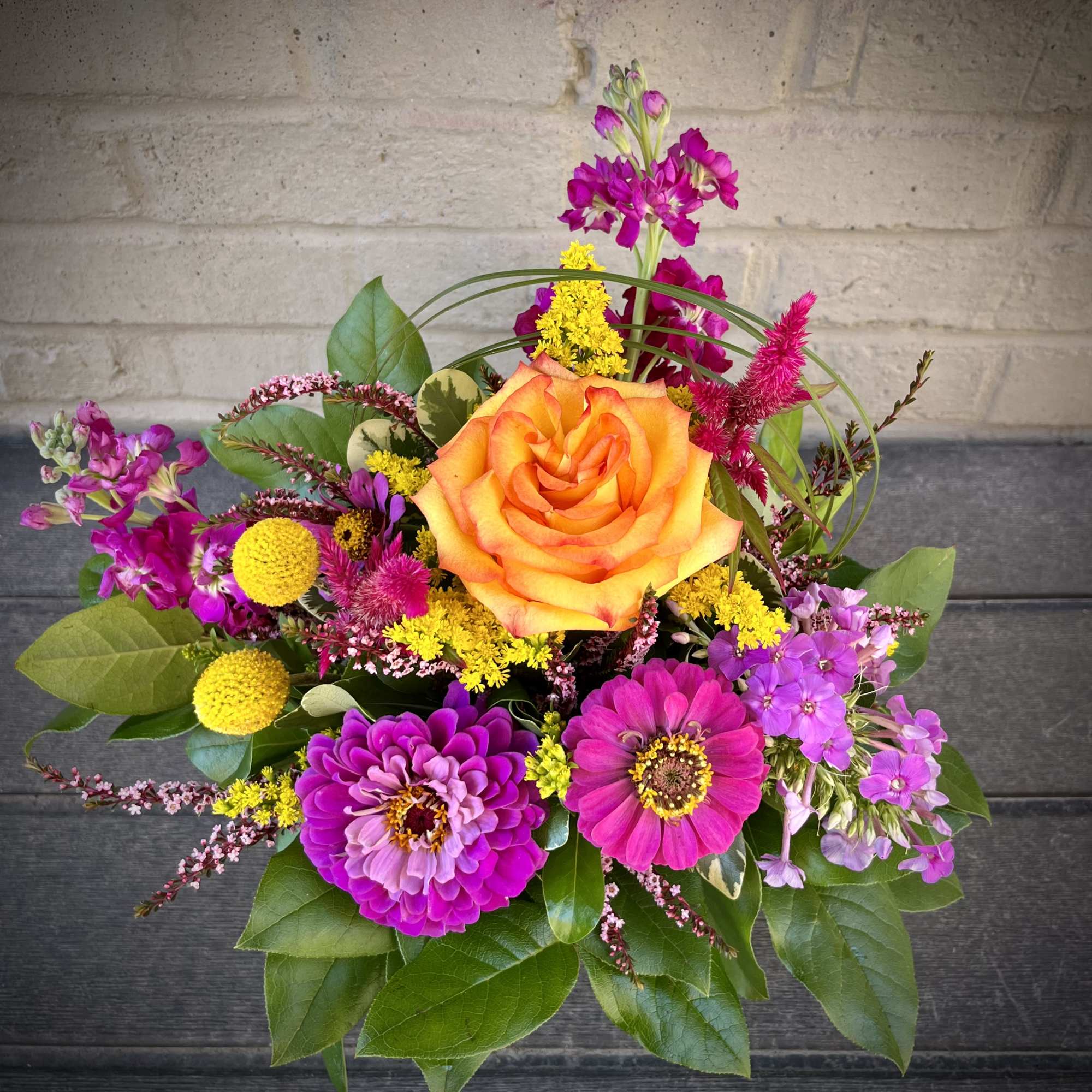 Bright mixed bouquet with an orange rose and pink flowers