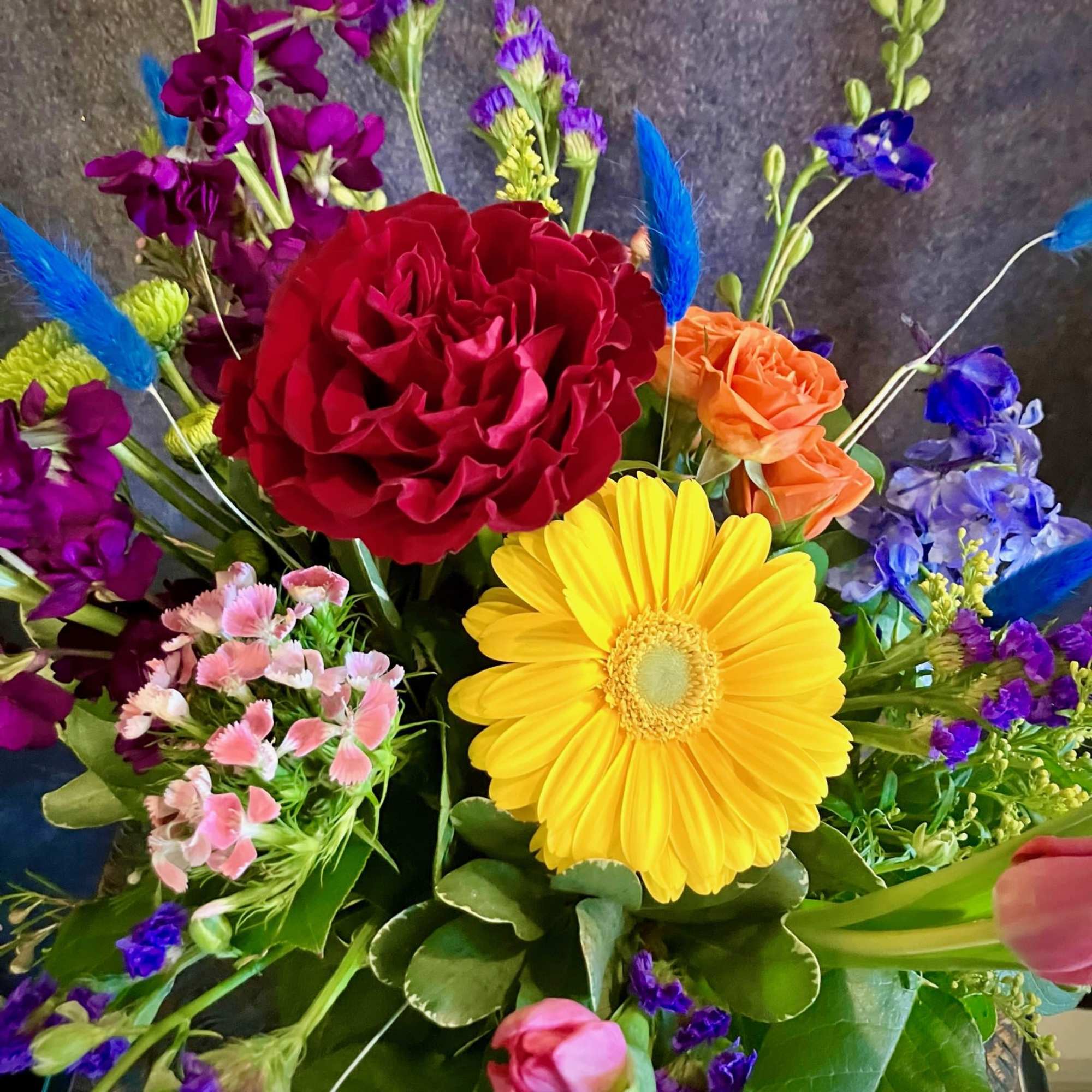 Colorful bouquet with red rose, yellow gerbera daisy, and purple flowers
