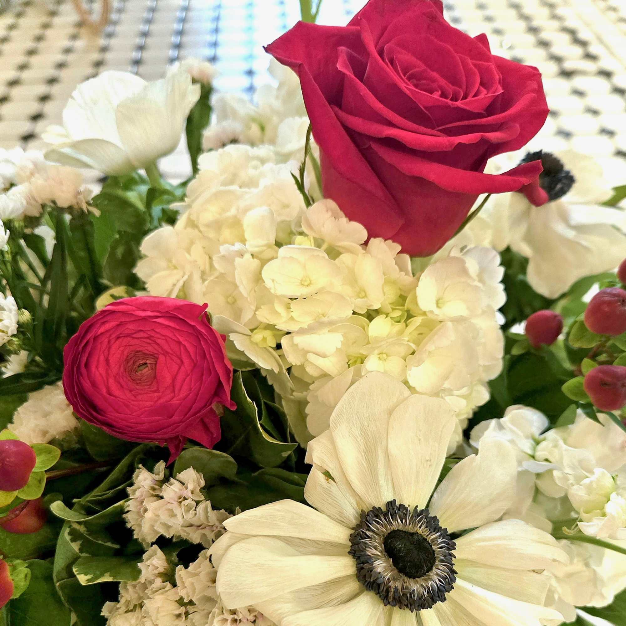 The Summer Picnic pairs vivid red roses and ranunculus with crisp white, photo 2 of 3