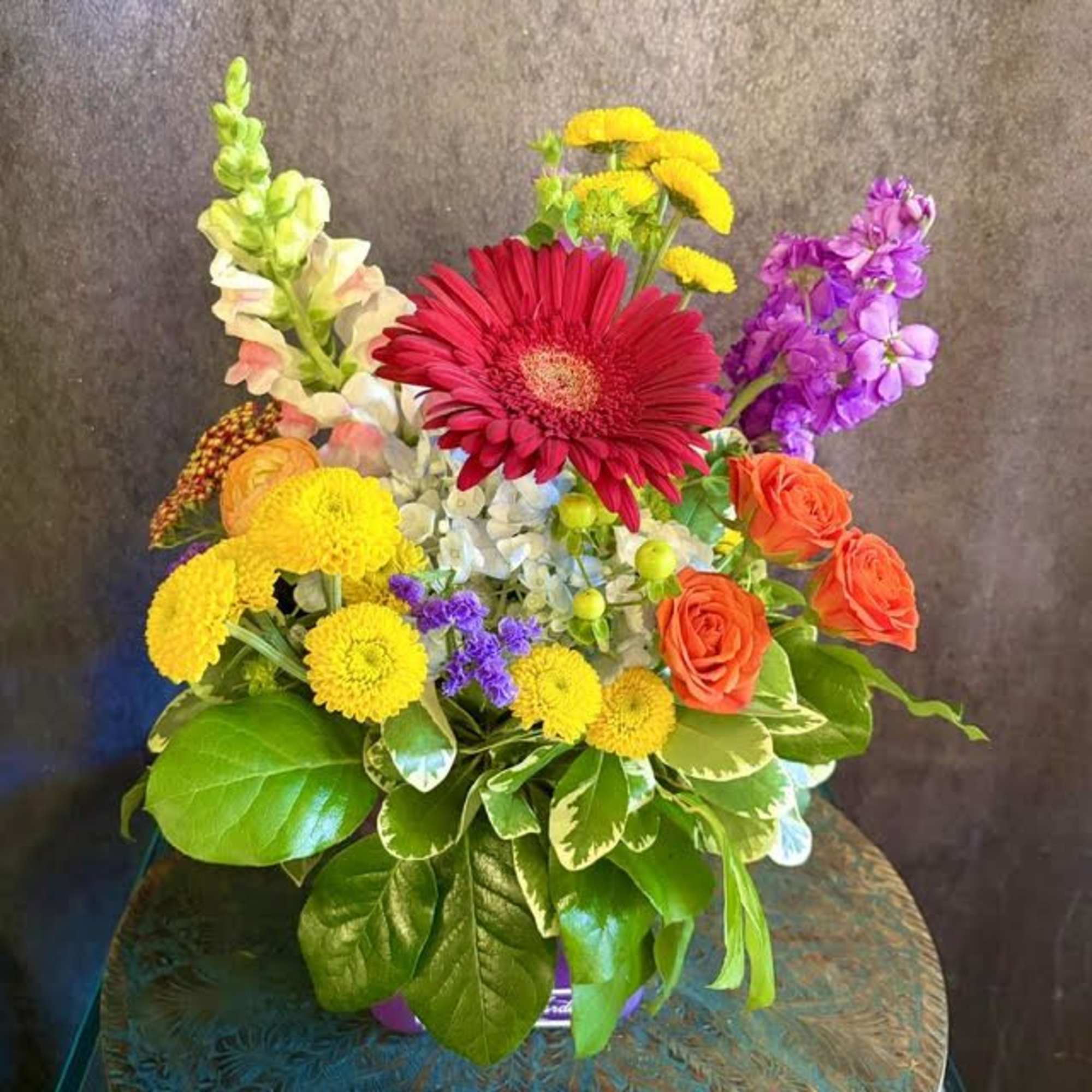 A bold red gerbera commands the center of this mixed-color flower arrangement, photo 2 of 3