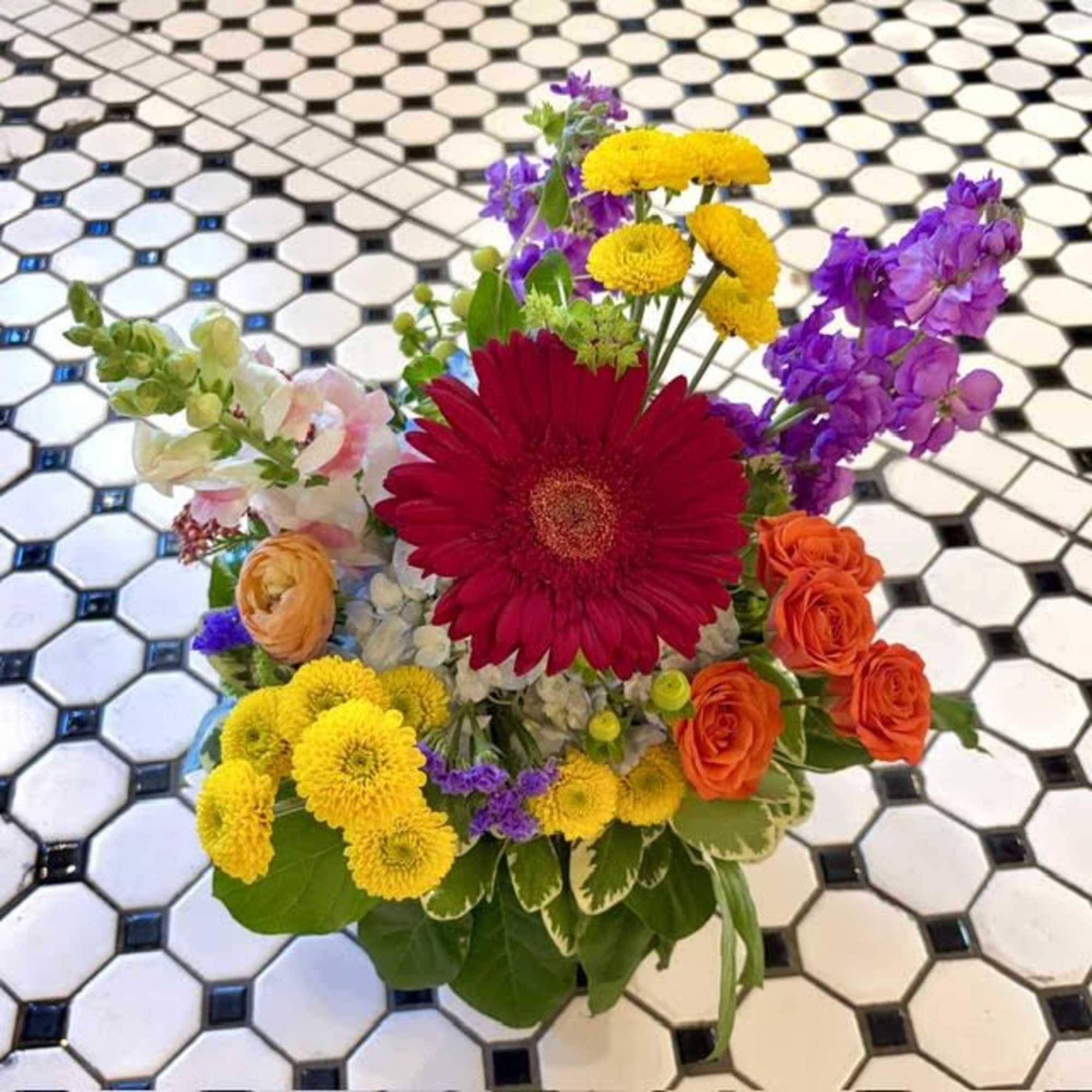 A bold red gerbera commands the center of this mixed-color flower arrangement, photo 3 of 3