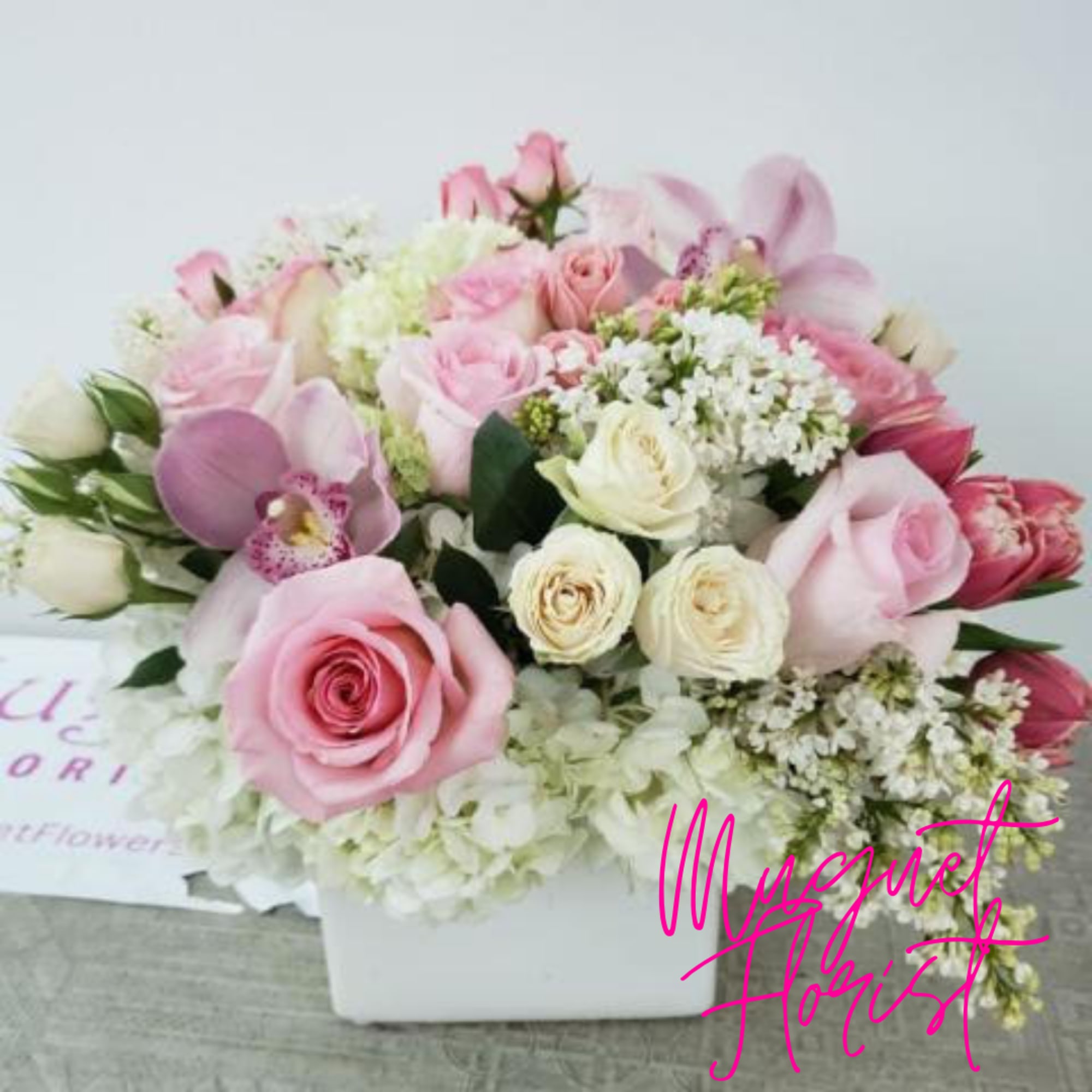 Pink and white rose bouquet in a white box with orchids and hydrangeas