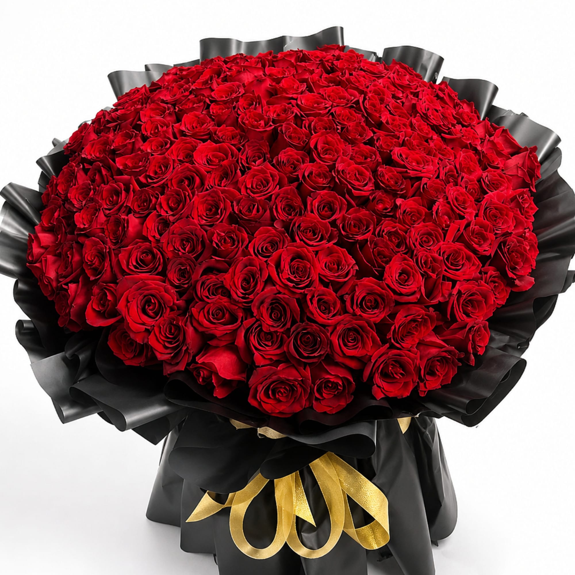 Large bouquet of red roses wrapped in black paper with a gold ribbon