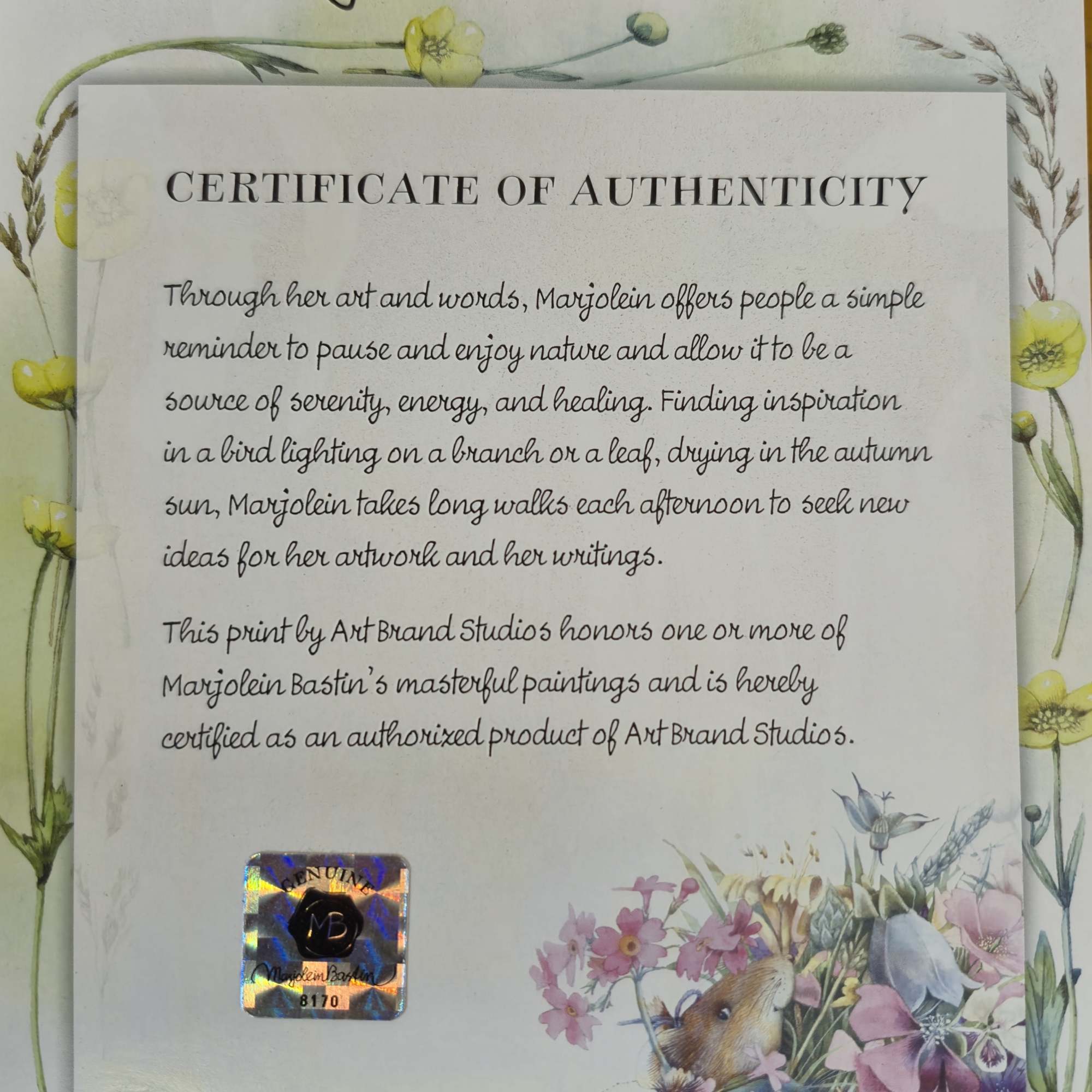 Certificate of authenticity with floral artwork and a holographic sticker