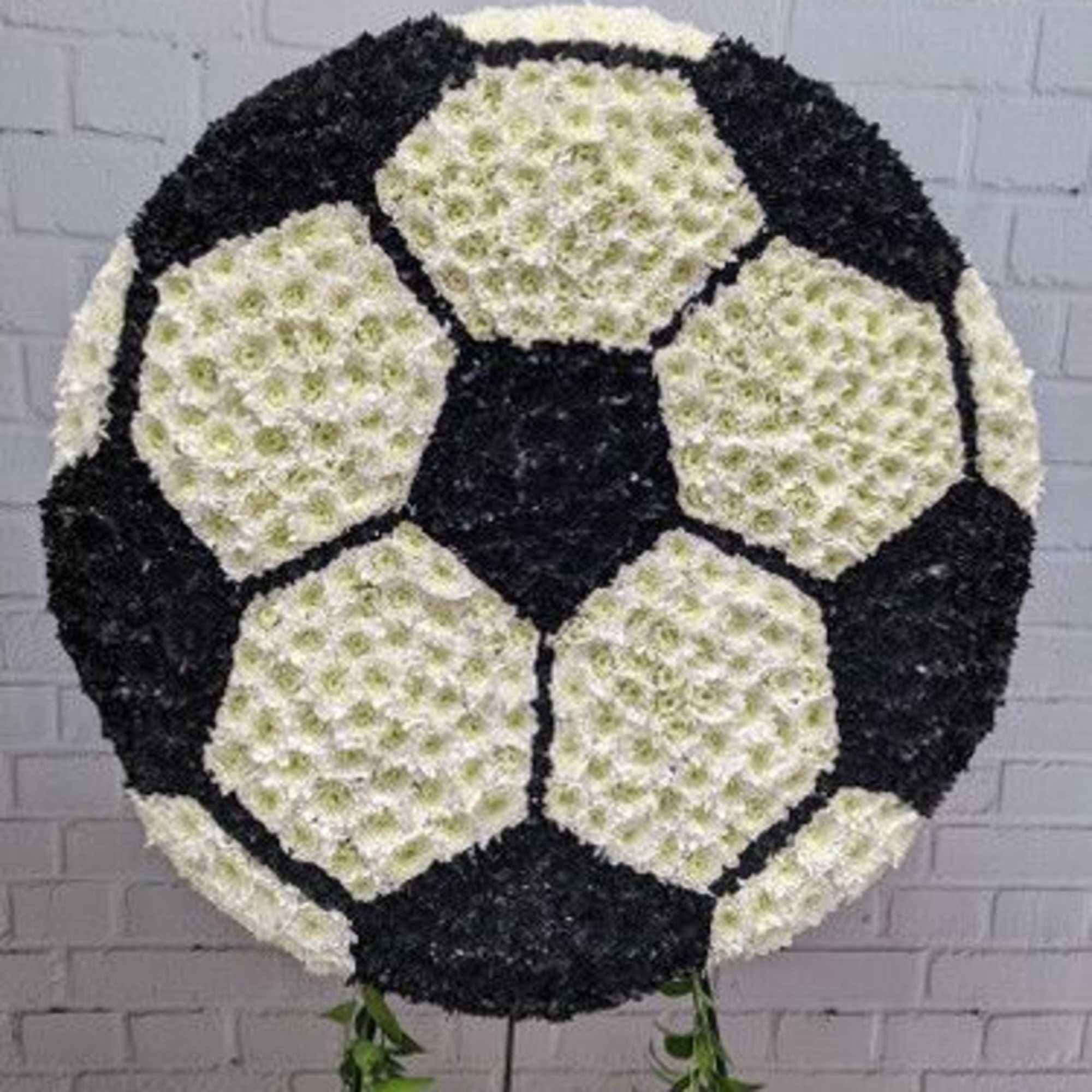 Soccer ball-shaped floral arrangement in black and white flowers