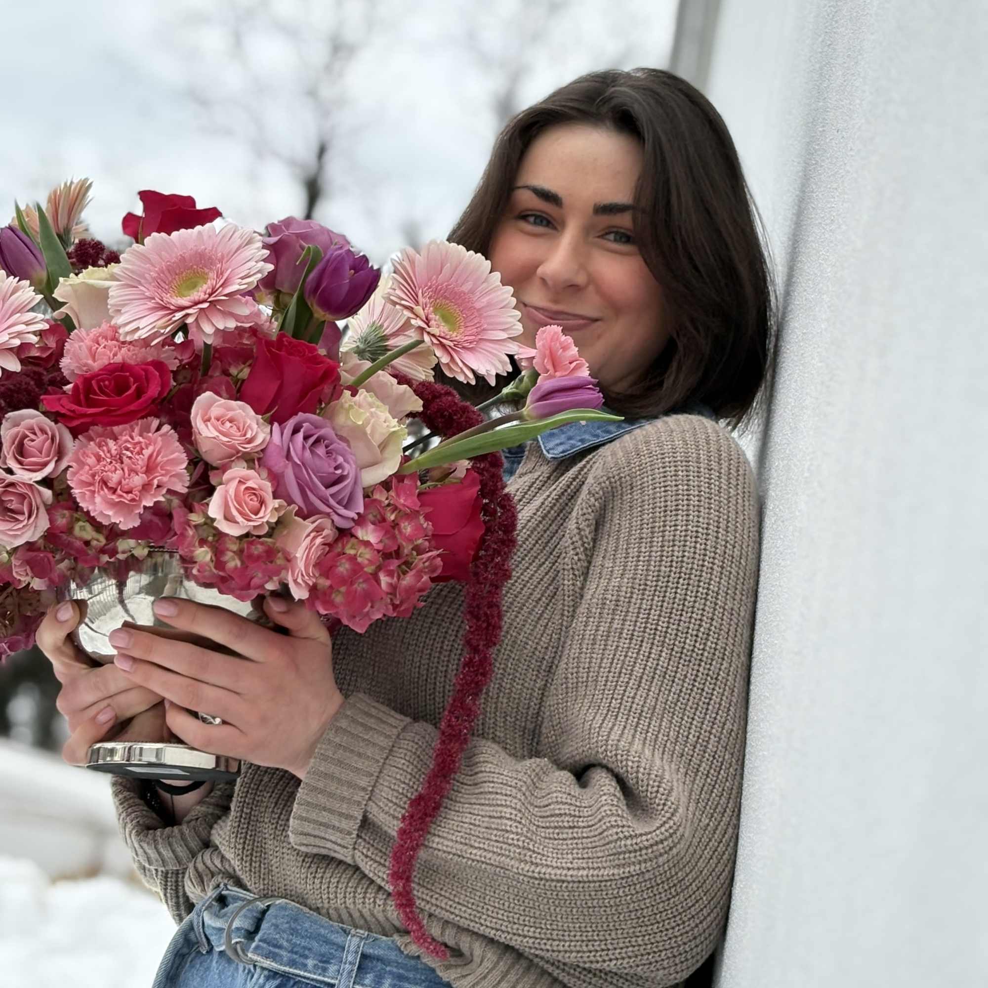 Woman holding a pink and purple mixed bouquet