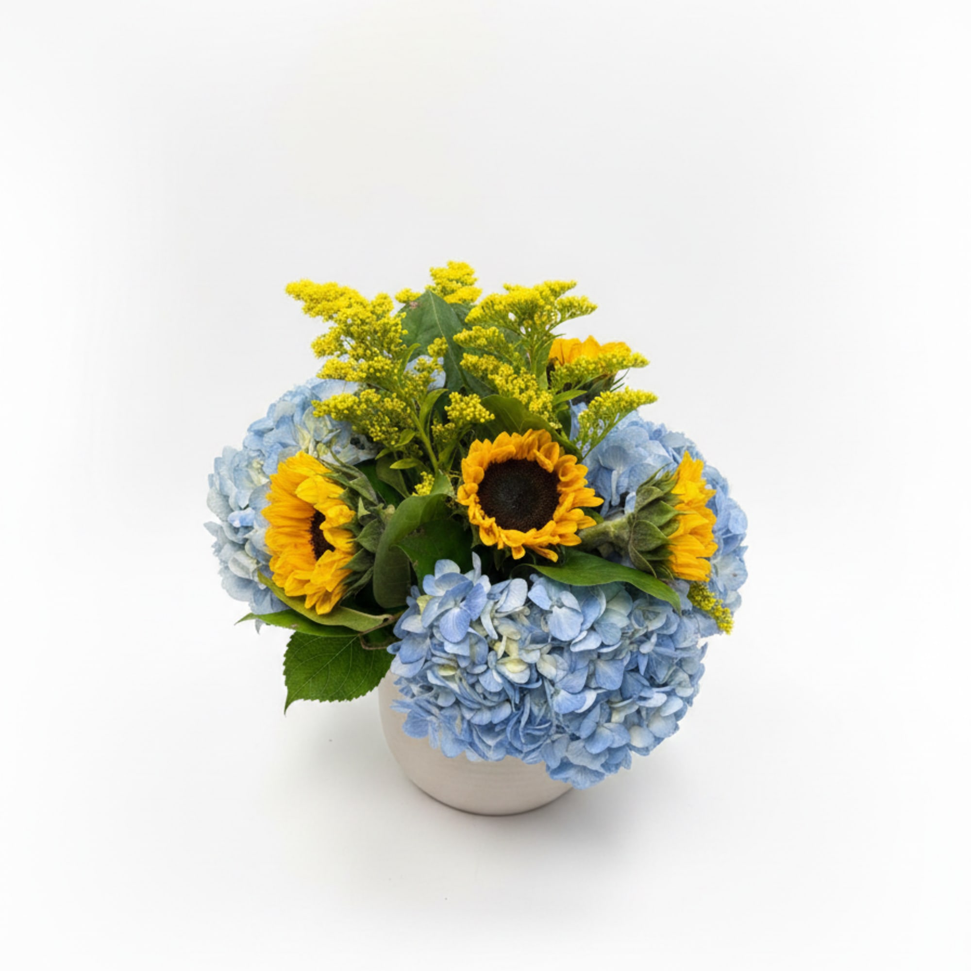 Blue hydrangeas form a lush, rounded mound punctuated by tall, sunny sunflowers-an, photo 2 of 2