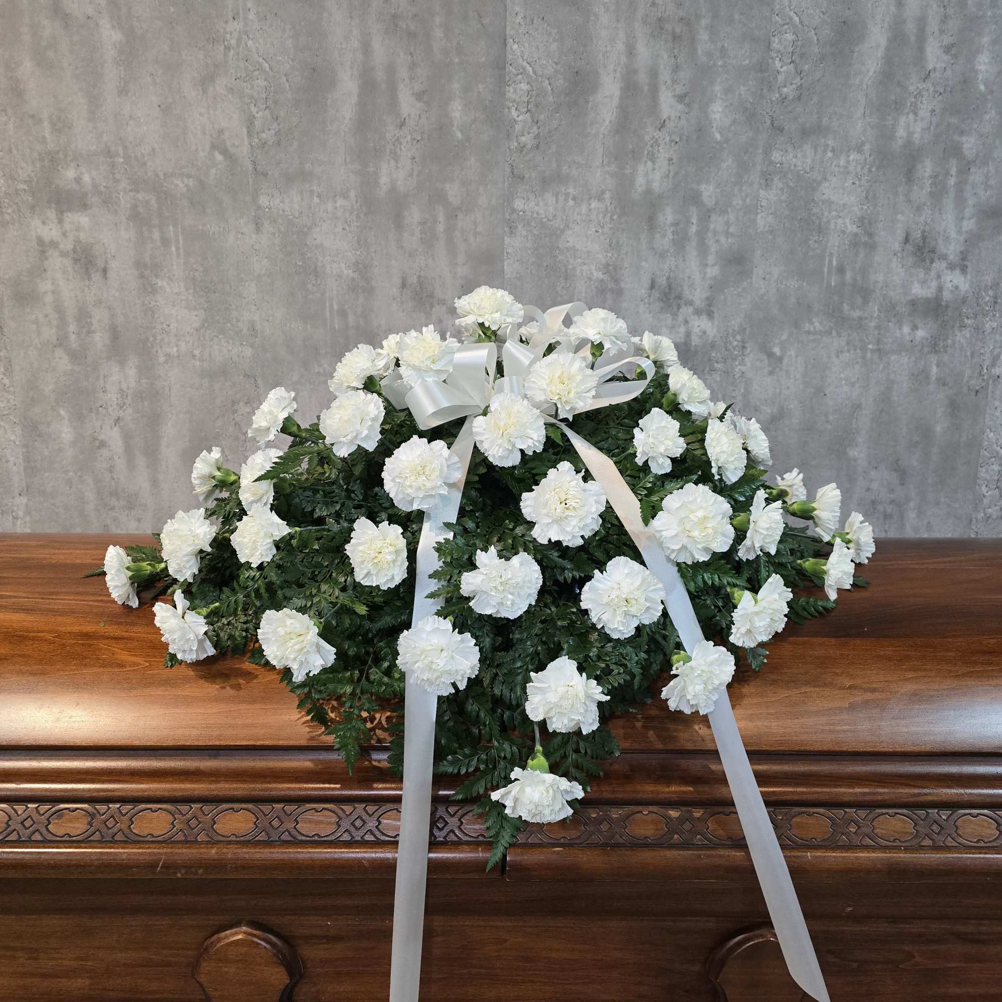 A classic carnation casket spray designed in red and white, but could, photo 2 of 3
