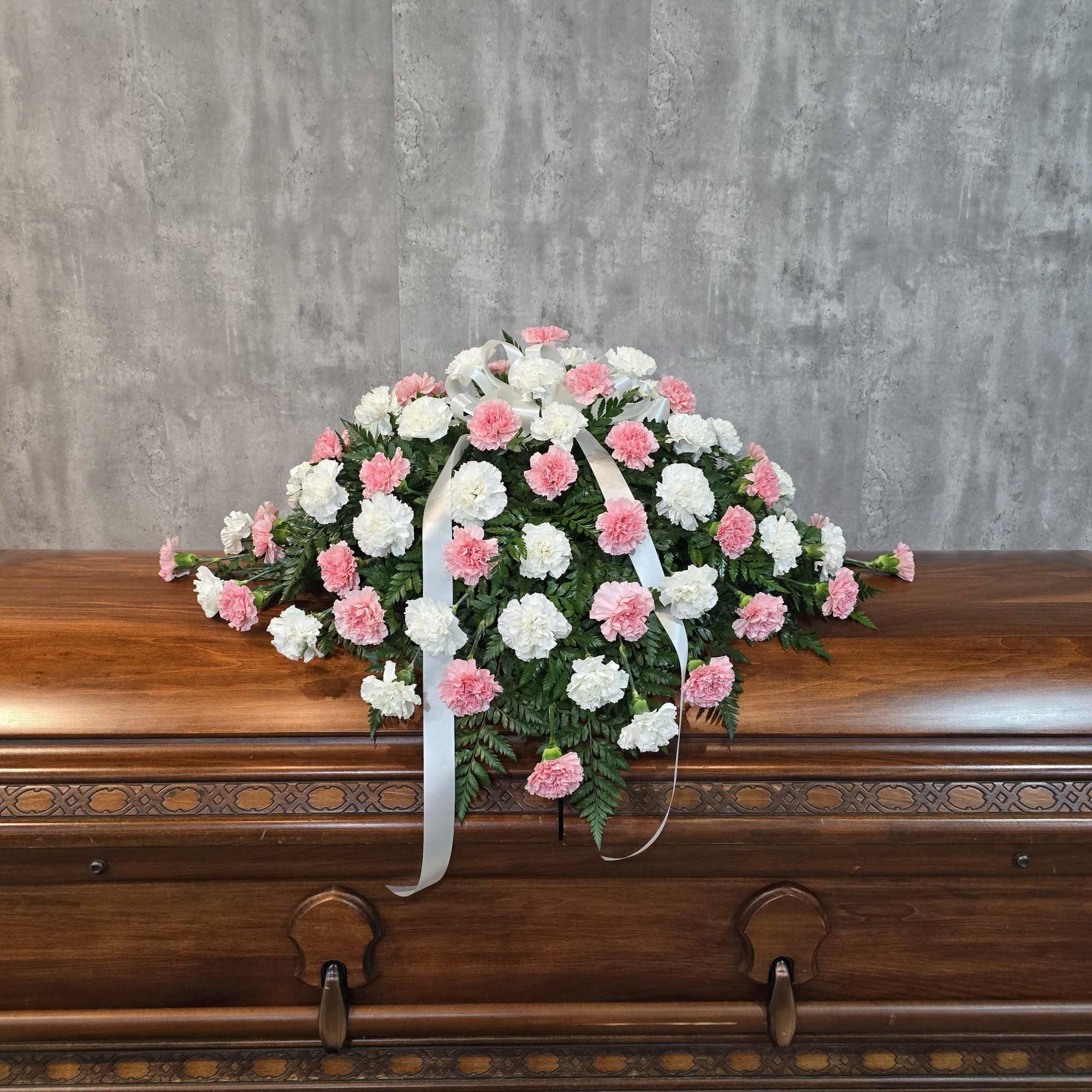 A classic carnation casket spray designed in red and white, but could, photo 3 of 3