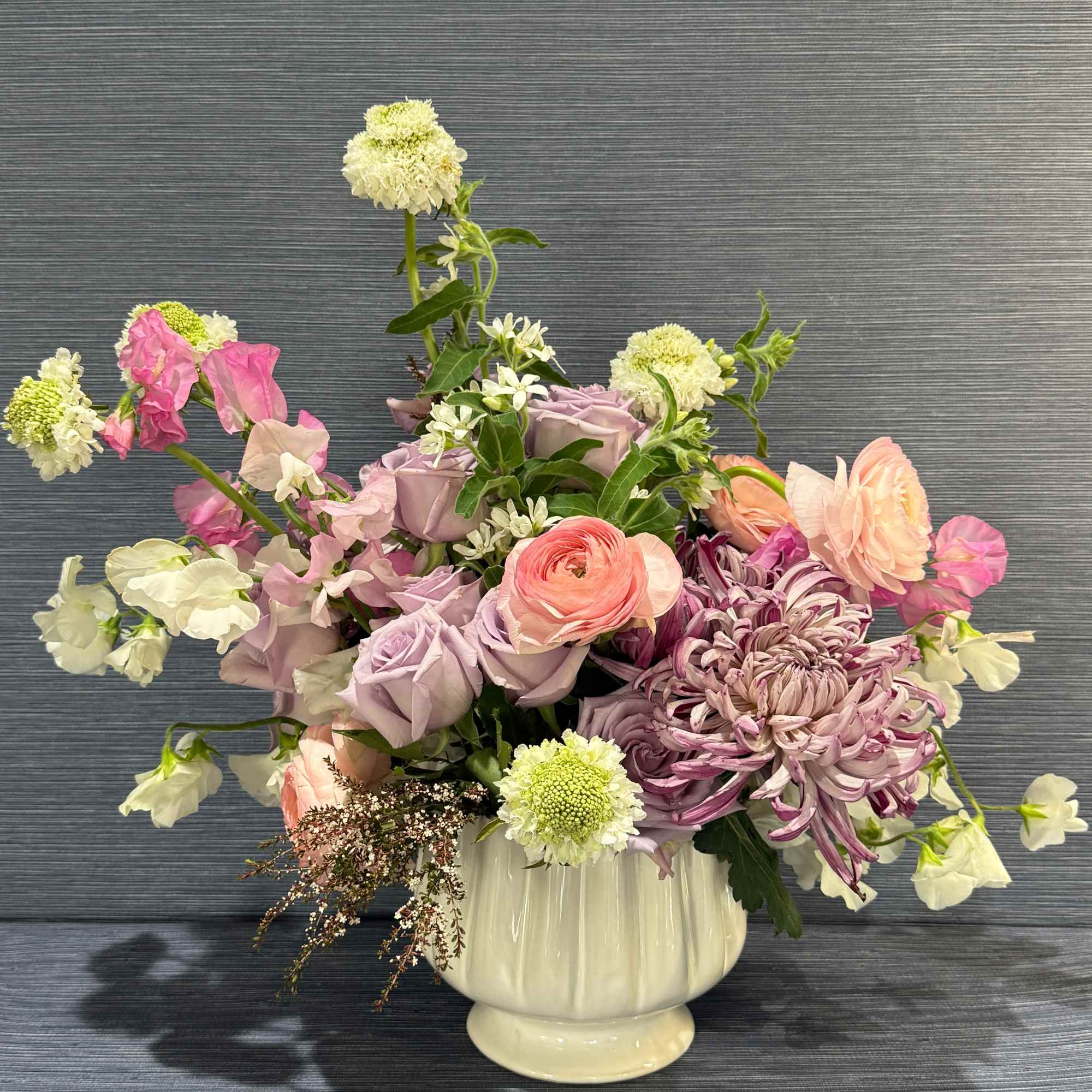 A soft, springlike blend of pinks, purples, whites, and fresh greens makes